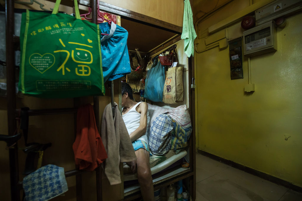 An occupant of a subdivided residential unit located inside a building in Hong Kong, on June 13, 2017. (Paul Yeung/Bloomberg via Getty)