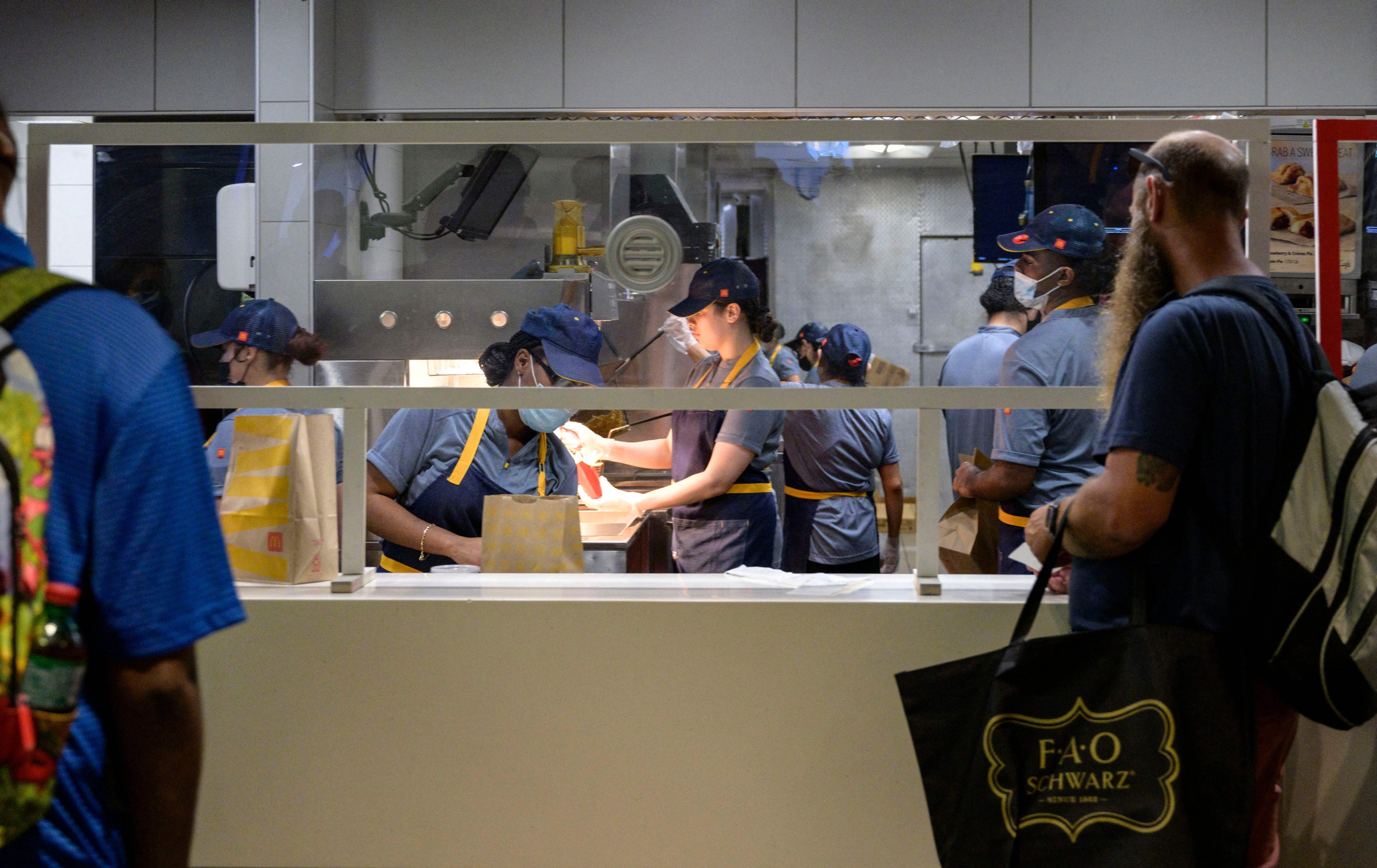 Employees prepare a customer's order at a McDonald's fast food restaurant in New York on May 27, 2022. (Angela Weiss — AFP via Getty Images)