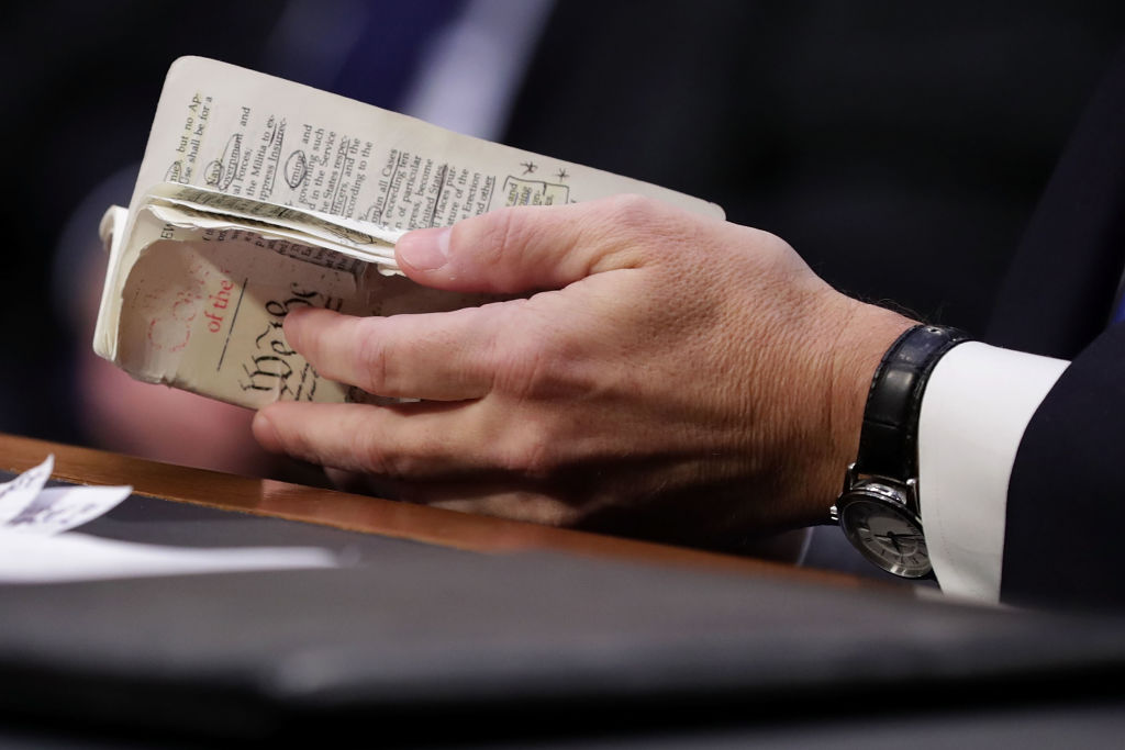 Brett Kavanaugh thumbs through a pocket-sized copy of the U.S. Constitution as he testifies during his Supreme Court confirmation hearing on Capitol Hill on Sept. 5, 2018 in Washington, D.C. (Chip Somodevilla—Getty Images)