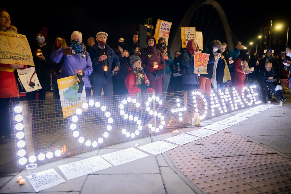 Participants in a vigil protest for financial compensation for those severely affected by climate change outside the site where the UN Climate Change Conference COP26 that took place in Glasgow, UK, on Nov. 10, 2021. (Christoph Soeder/picture alliance—Getty Images)