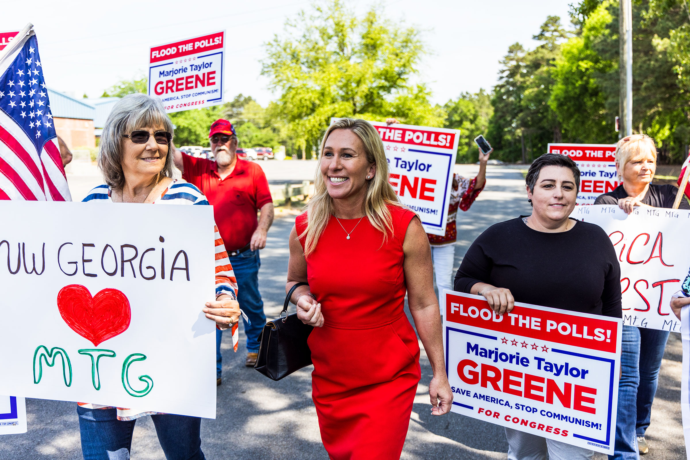 Marjorie Taylor Greene walks with supporters to cast her primary ballot in Rome, Ga., on the first day of early voting. (Andrew Hetherington for TIME)