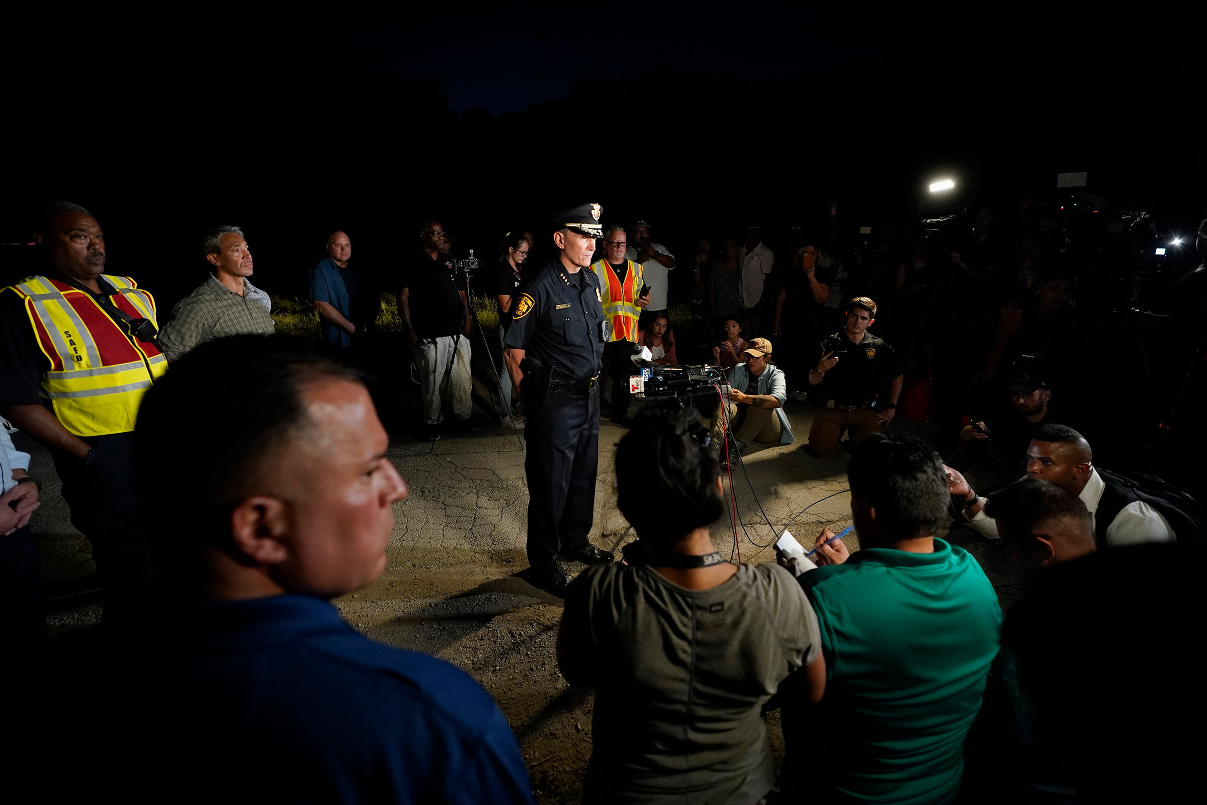 San Antonio Police Chief William McManus, center, briefs media and others at the scene where dozens of people have been found dead and multiple others were taken to hospitals with heat-related illnesses after a semitrailer containing suspected migrants was found, Monday, June 27, 2022, in San Antonio. (Eric Gay—AP)