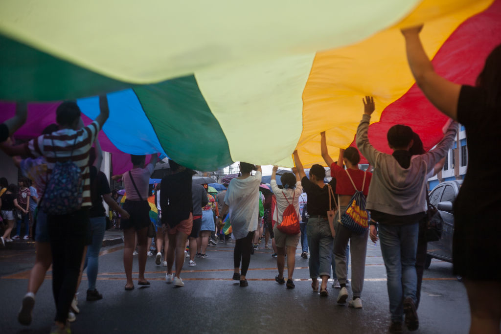 Members of the lesbian, gay, bisexual, and transgender (LGBT) community carry a giant rainbow flag along a highway during the annual LGBT pride celebration in Marikina City, east of Manila, Philippines, on 30 June 2018. (Richard James Mendoza—NurPhoto/Getty Images)