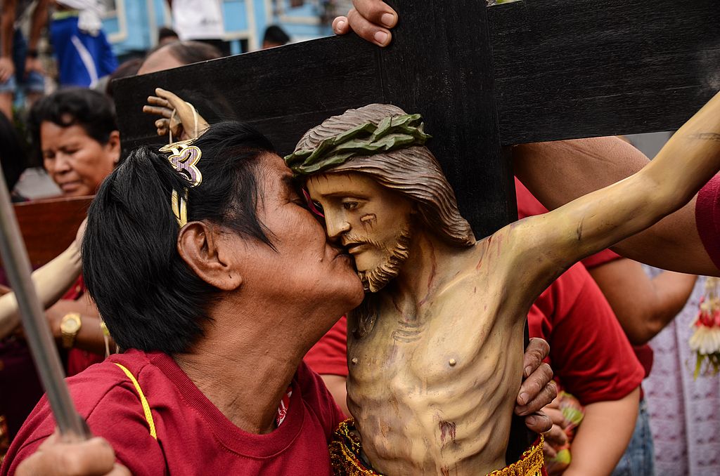 A devotee kisses an idol of Jesus Christ during the start of the Feast of the Black Nazarene on January 7, 2014 in Manila, Philippines. (Dondi Tawatao/Getty Images)