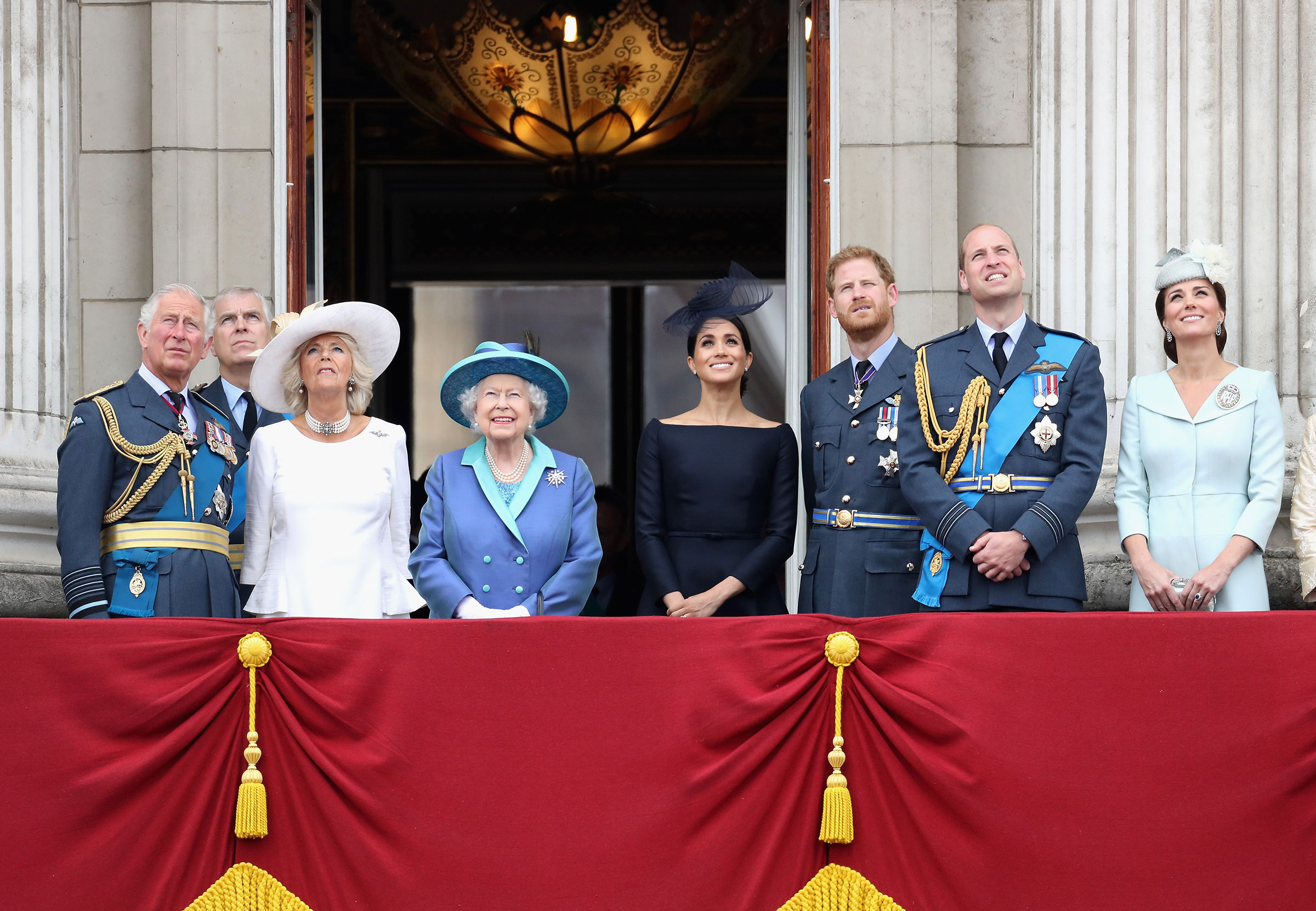 Prince Charles, Prince of Wales, Prince Andrew, Duke of York, Camilla, Duchess of Cornwall, Queen Elizabeth II, Meghan, Duchess of Sussex, Prince Harry, Duke of Sussex, Prince William, Duke of Cambridge and Catherine, Duchess of Cambridge watch the RAF flypast on the balcony of Buckingham Palace, as members of the Royal Family attend events to mark the centenary of the RAF on July 10, 2018. (Chris Jackson—Getty Images)