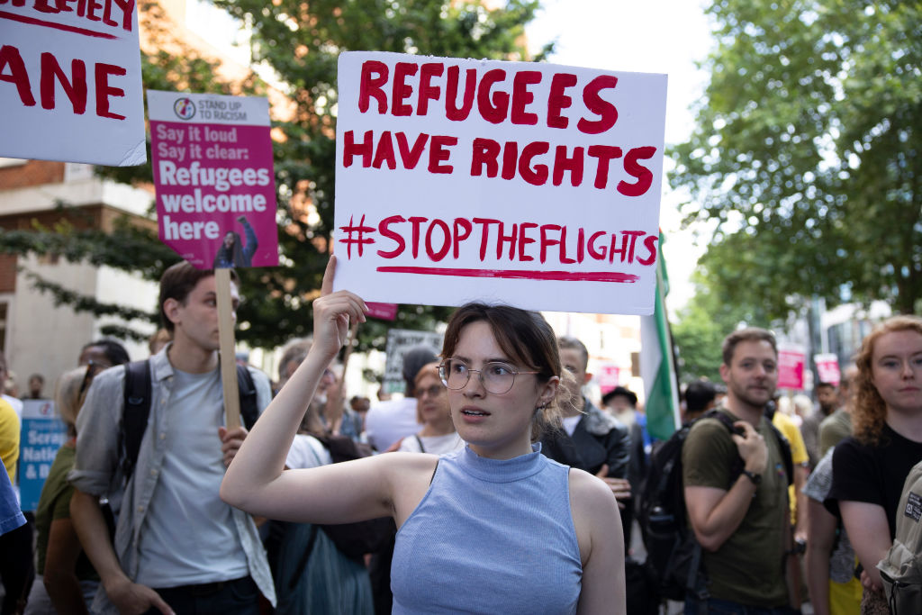 A protester holds a placard during a demonstration against the deportation of asylum seekers to Rwanda, outside the Home Office, London, United Kingdom, on June 6 2022. (Hesther Ng—SOPA Images/LightRocket/Getty Images)
