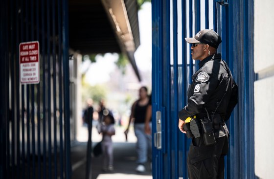 A Fullerton Police Department sergeant stands near the entrance to Richman Elementary School