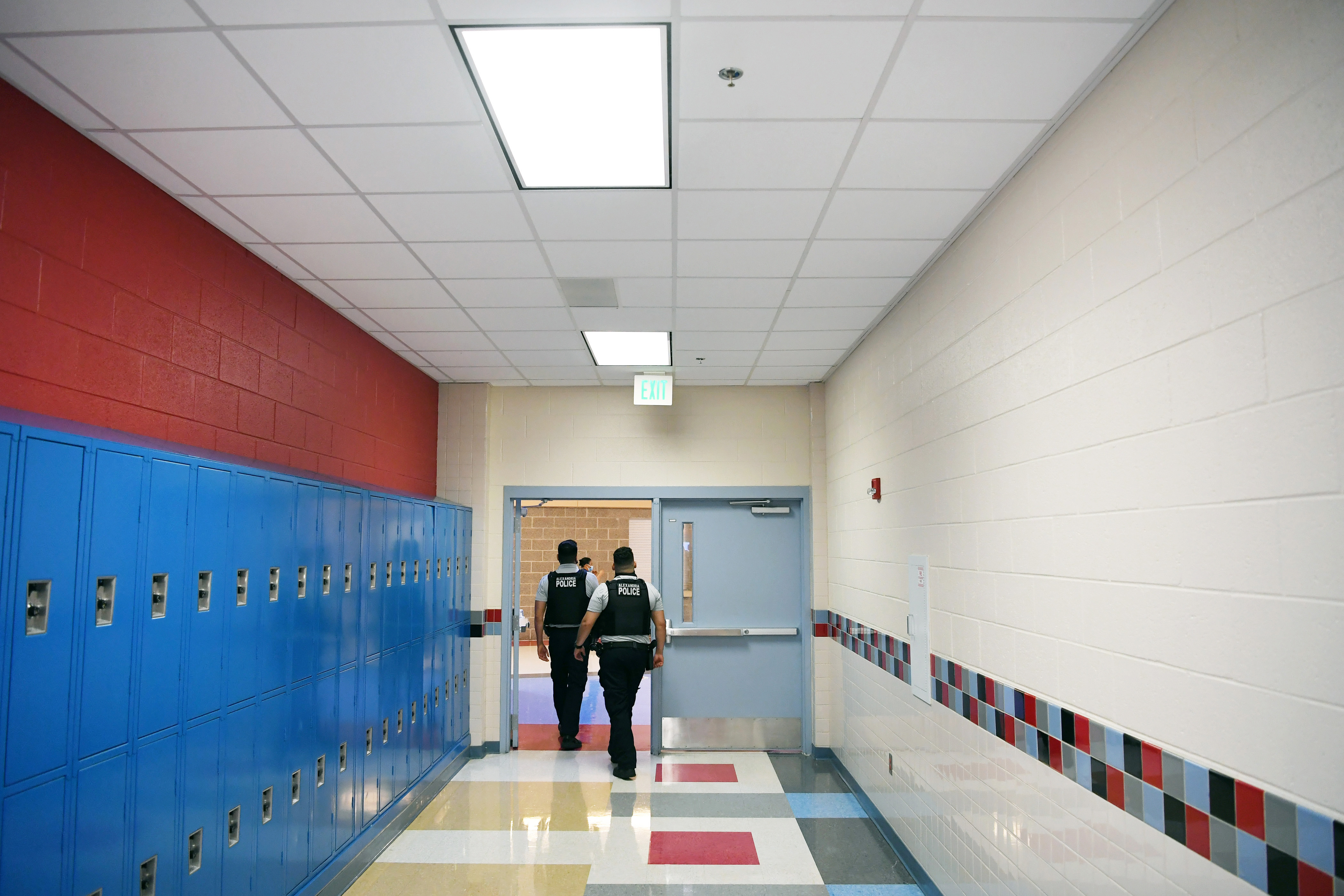 Alexandria Police Department school resource officers walk through a hallway at T.C. Williams High School on June 9, 2021 in Alexandria, Va. (Matt McClain—The Washington Post/Getty Images)