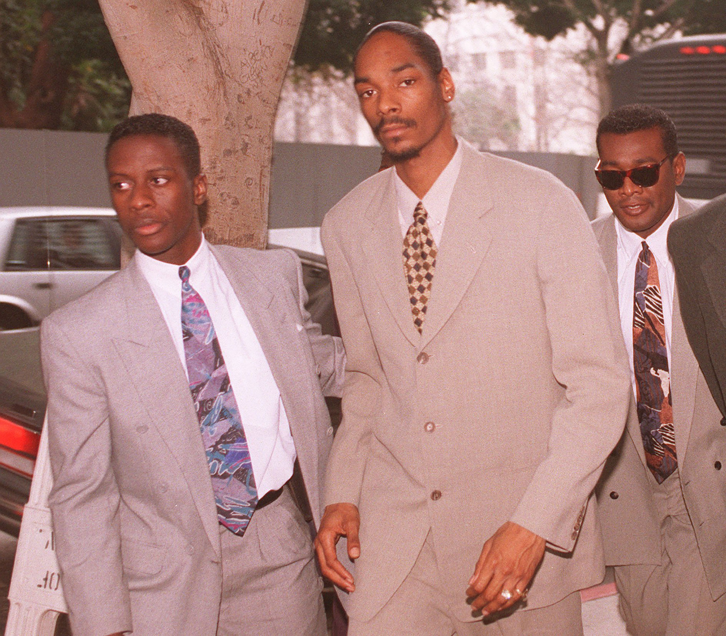 Snoop Dogg, center, is escorted into the Los Angeles Criminal Courts building where he and a former bodyguard were on trial for a 1993 murder, on Feb. 9, 1996. (Mark J. Terrill—AP)