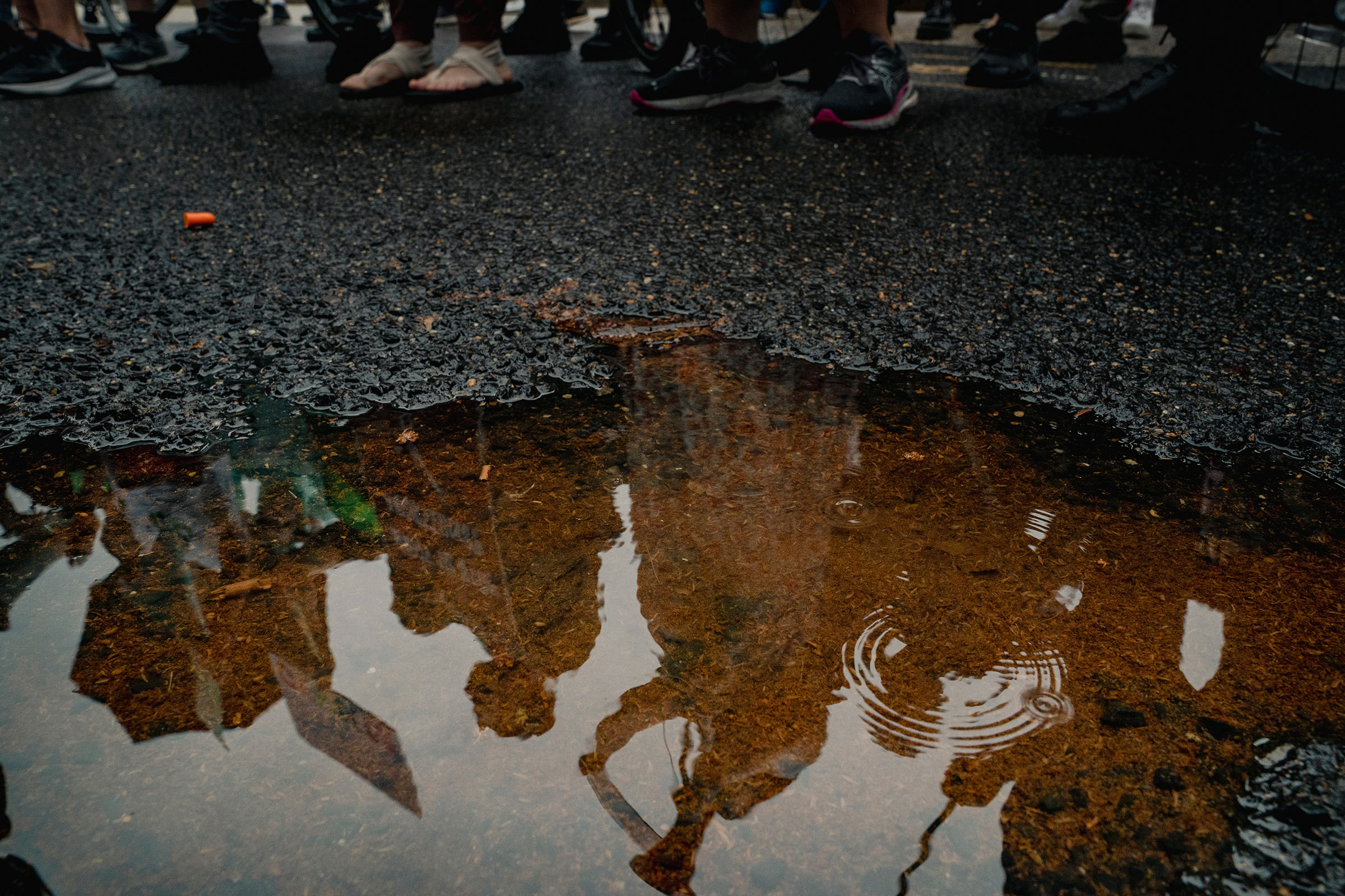 A reflection of supporters and opponents of abortion rights demonstrating is seen outside the Supreme Court Building in Washington on June 23, 2022. (Shuran Huang for TIME)