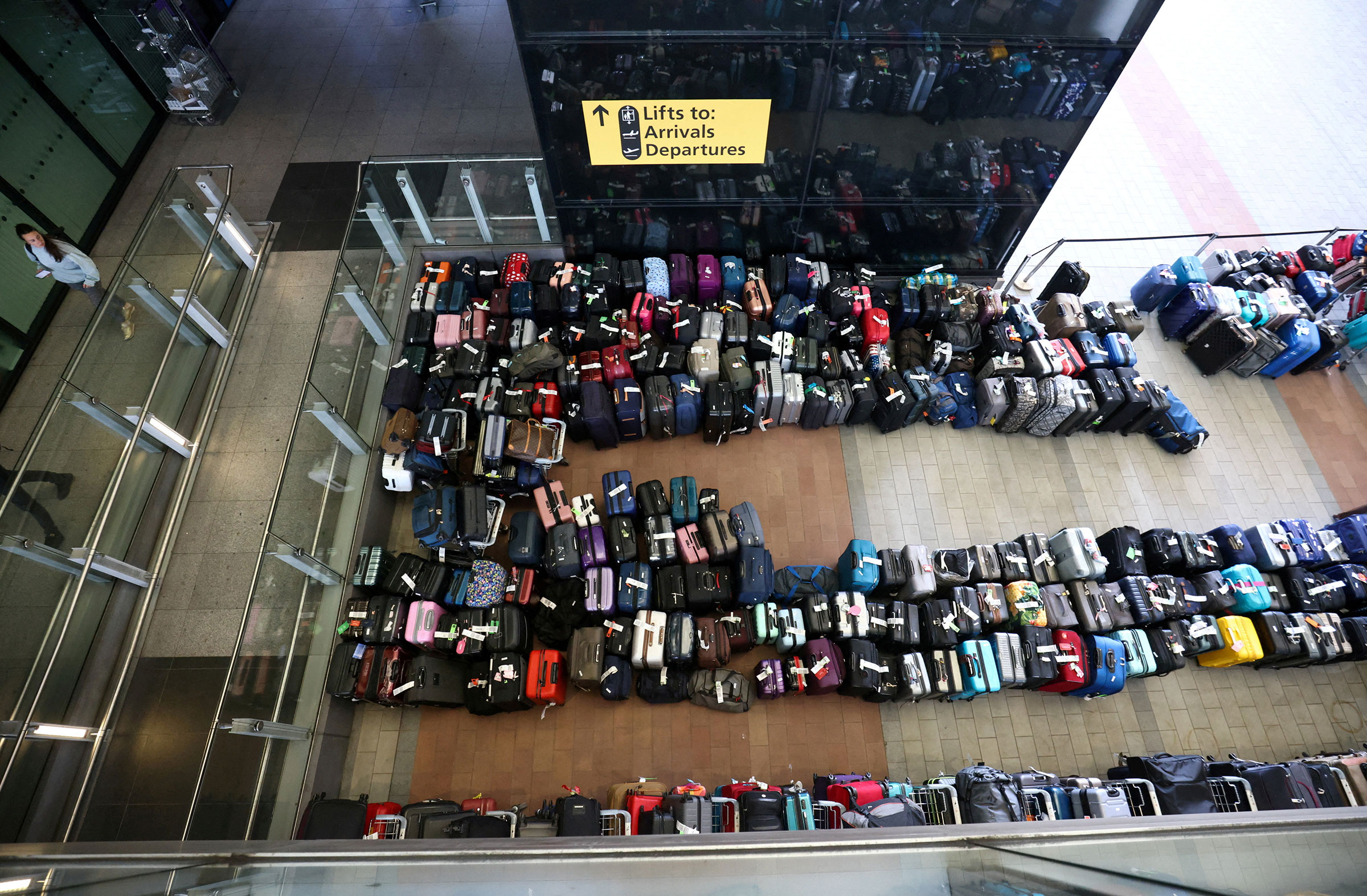 Lines of passenger luggage lie arranged outside Terminal 2 at Heathrow Airport in London, on June 19, 2022. (Henry Nicholls—Reuters)