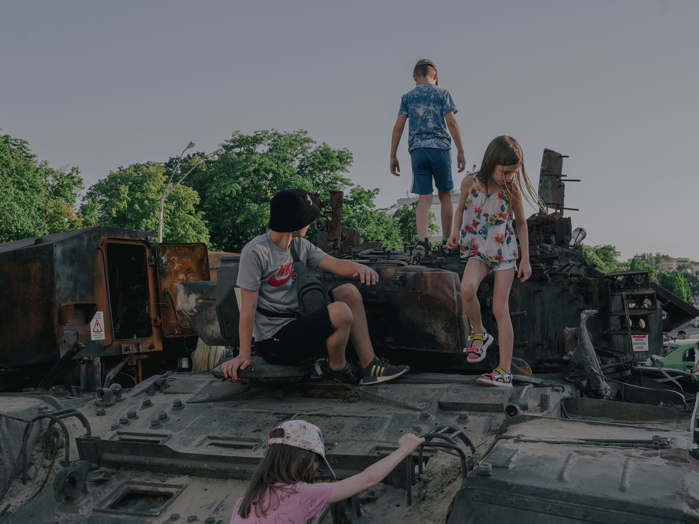 Children play on destroyed Russian war equipment in front of St. Michael‘s Monastery in Kyiv on June 12, 2022. (Fabian Ritter—DOCKS Collective)