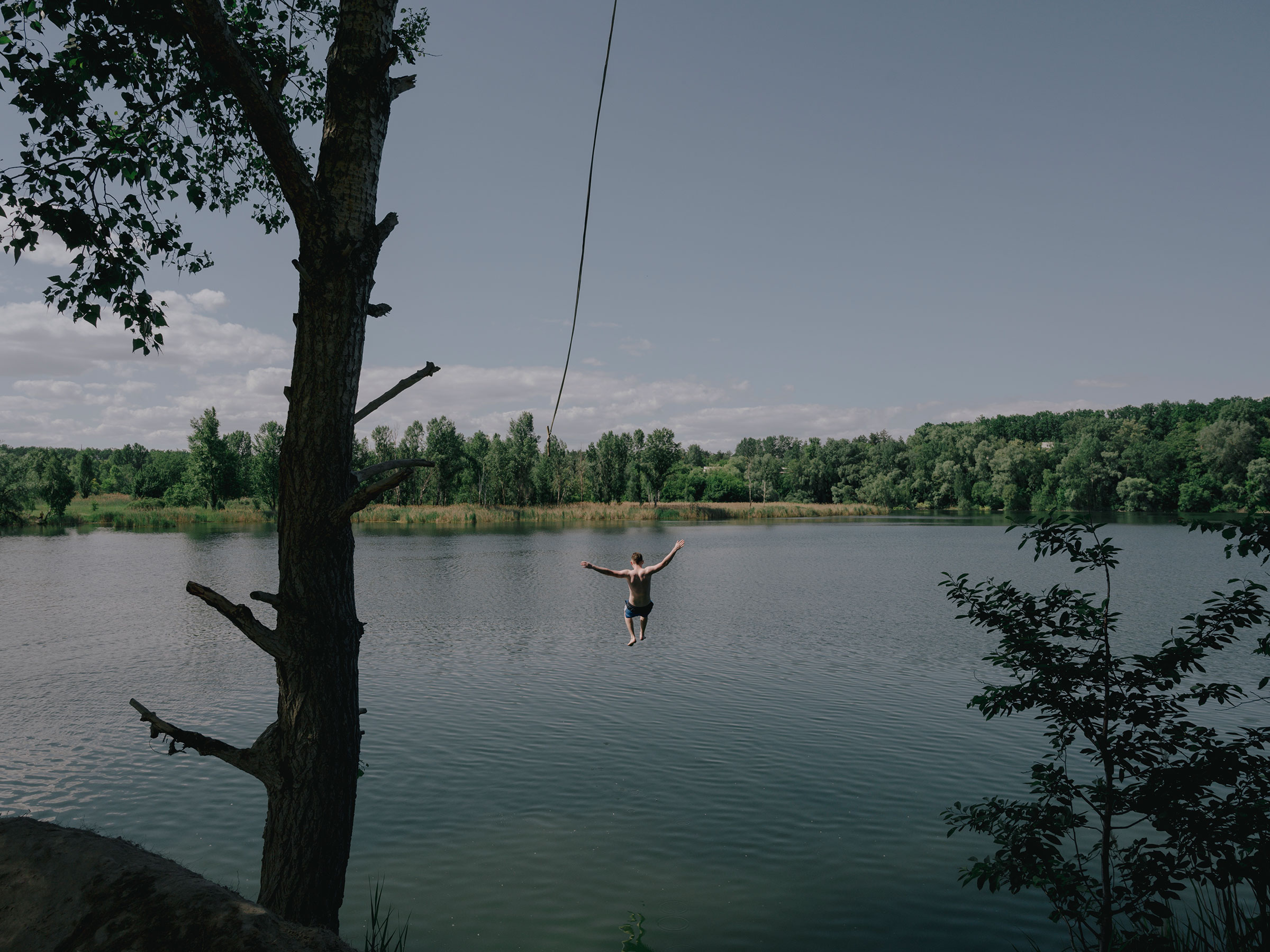 Youth from Irpin and Bucha go for a swim in a lake near Kyiv. (Fabian Ritter—DOCKS Collective)