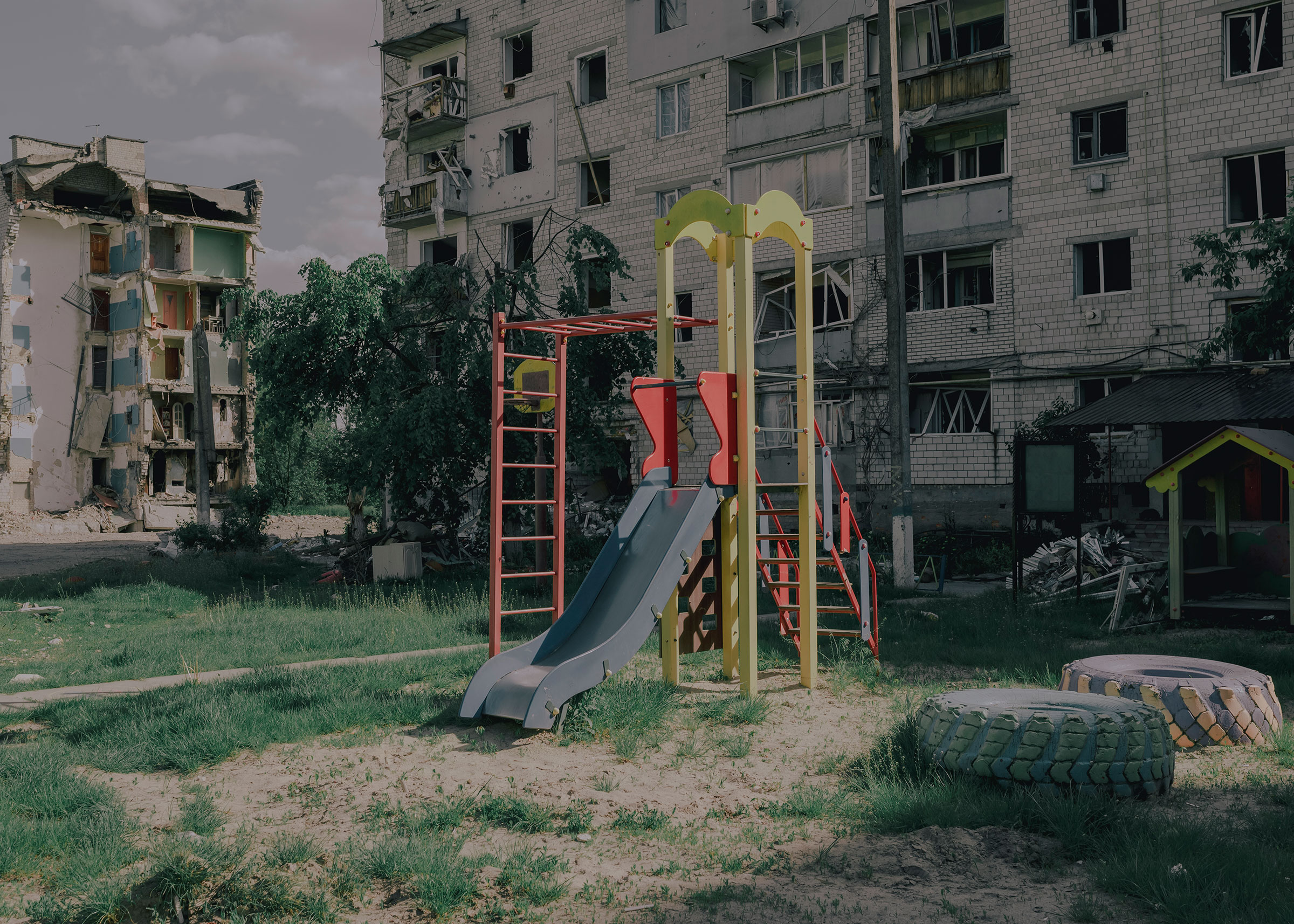 A play structure behind several destroyed buildings is still used by children. (Fabian Ritter—DOCKS Collective)