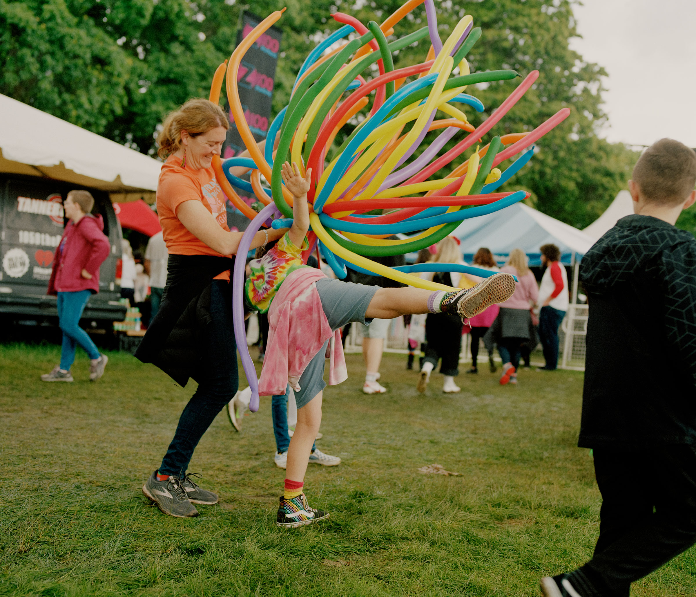 Karen and her kids play with balloons at Portland’s Pride festival on June 19, 2022. (Ricardo Nagaoka for TIME)