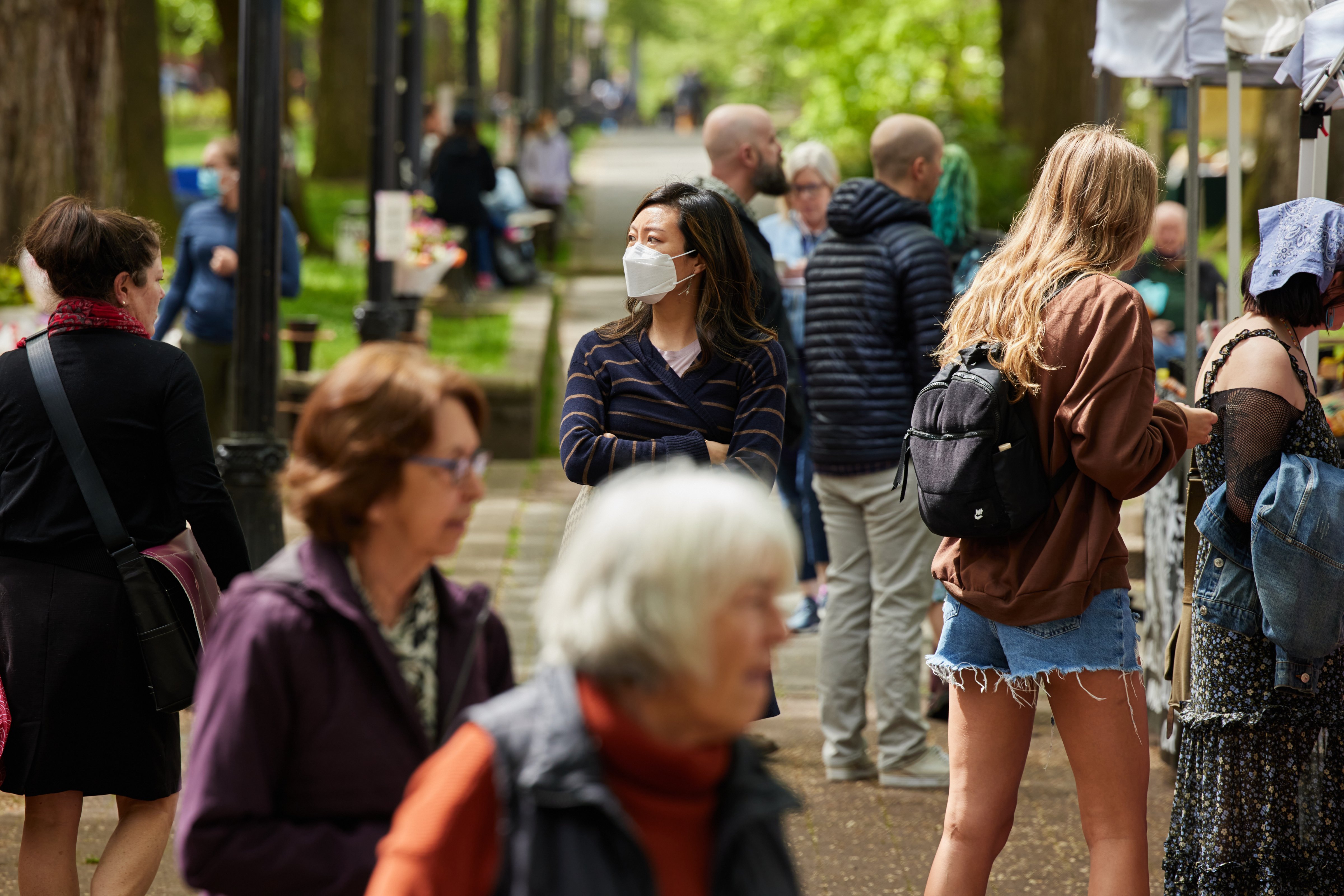 On Wednesday, May 4th, 2022 a mix of masked and unmasked individuals shop at the Portland Farmers Market in Shemanski Park in Portland, OR. (Leah Nash for the Washington Post)