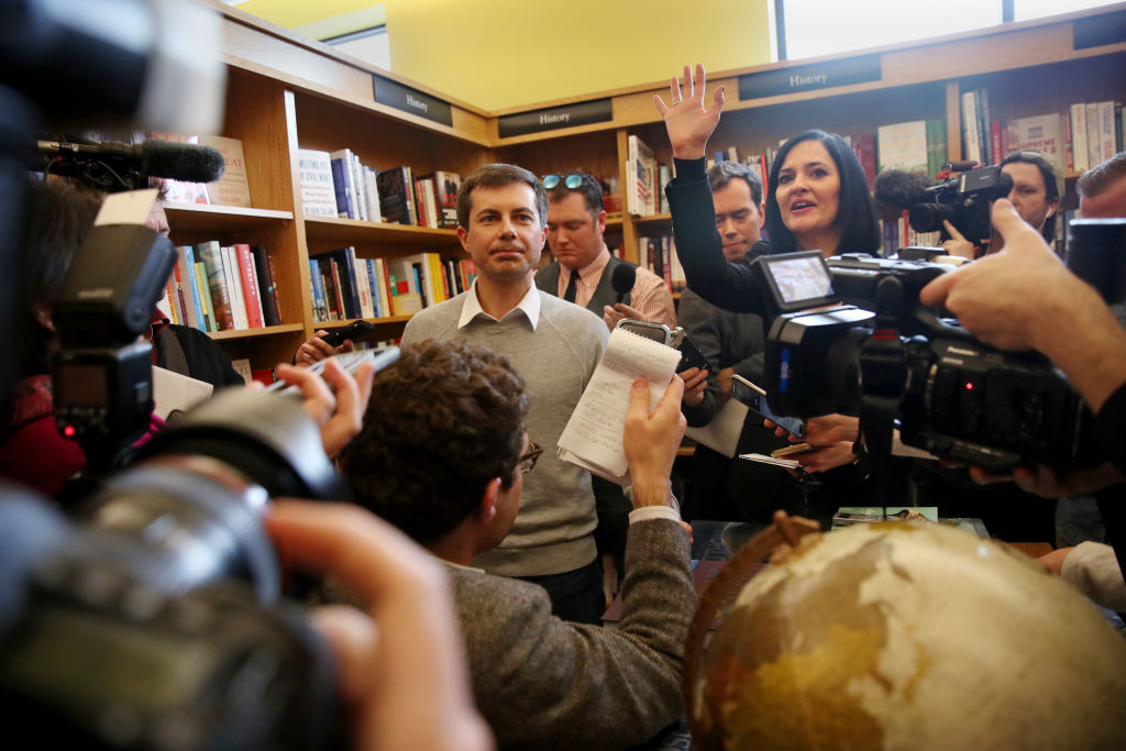 Pete Buttigieg, left, mayor of South Bend, IN, takes questions from the media with his communication advisor, Lis Smith, right, in Concord, NH on April 6, 2019. (Craig F. Walker/The Boston Globe—Getty Images)