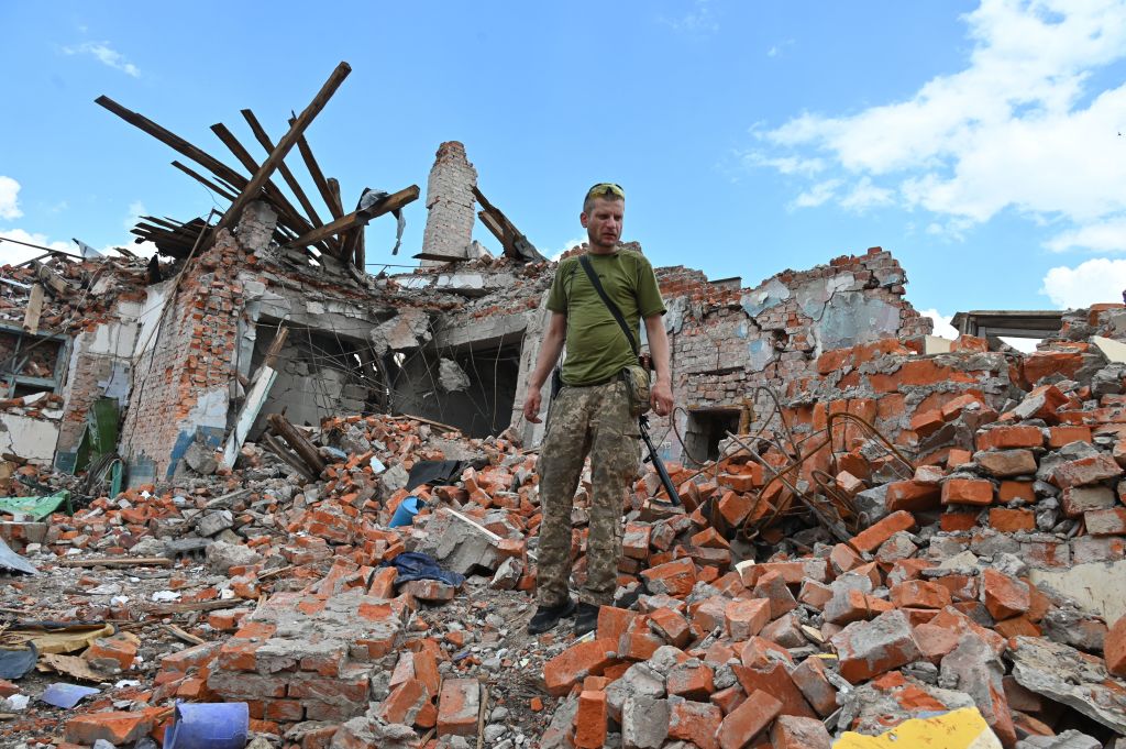 A Ukrainian serviceman inspects the ruins of Lyceum building, after a suspected missile strike near Kharkiv on July 5, 2022. (Sergey Bobok—AFP via Getty Images)