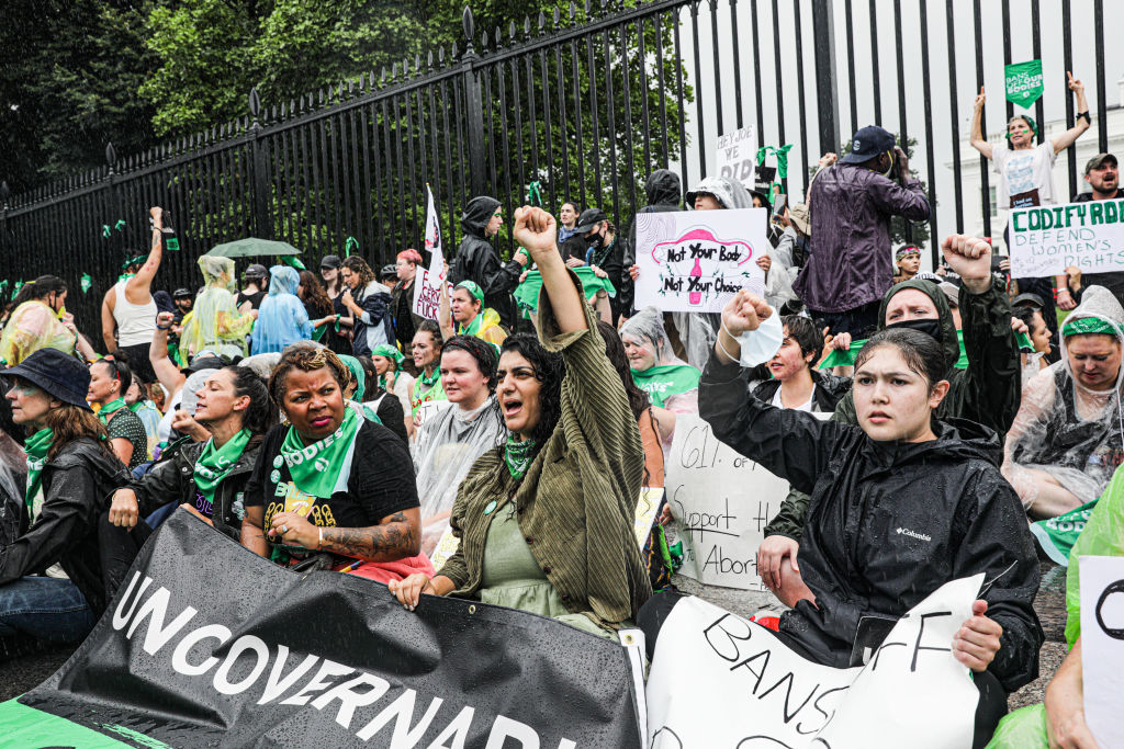 Demonstrators hold a sit-in in front of the White House during a Women's March rally in Washington, on July 9, 2022. (Valerie Plesch—Bloomberg/Getty Images)