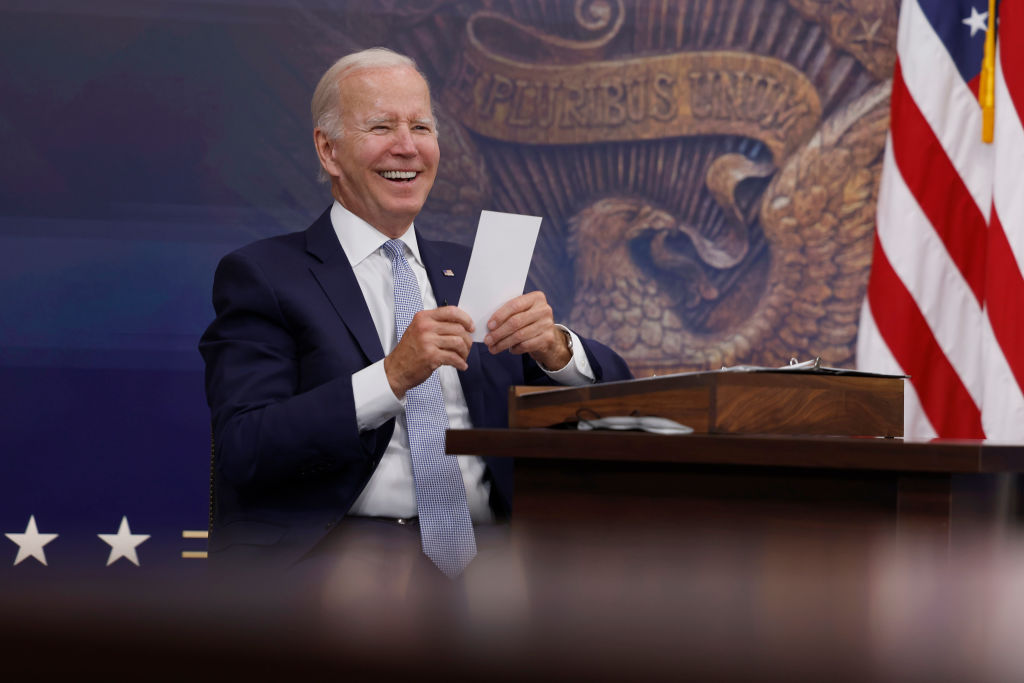 President Joe Biden reads a note from an aide saying that the Creating Helpful Incentives to Produce Semiconductors (CHIPS) for America Act had received enough support in the House of Representatives to pass during a meeting at the White House on July 28, 2022 in Washington, DC. (Anna Moneymaker—Getty Images)