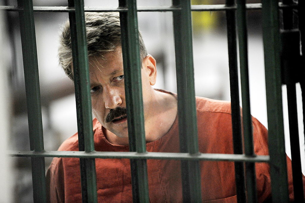 Alleged Russian arms dealer Viktor Bout looks on as he stands behind bars ahead of a court hearing at the Criminal Court in Bangkok, on March 6, 2009. (Christophe Archambault—AFP/Getty Images)