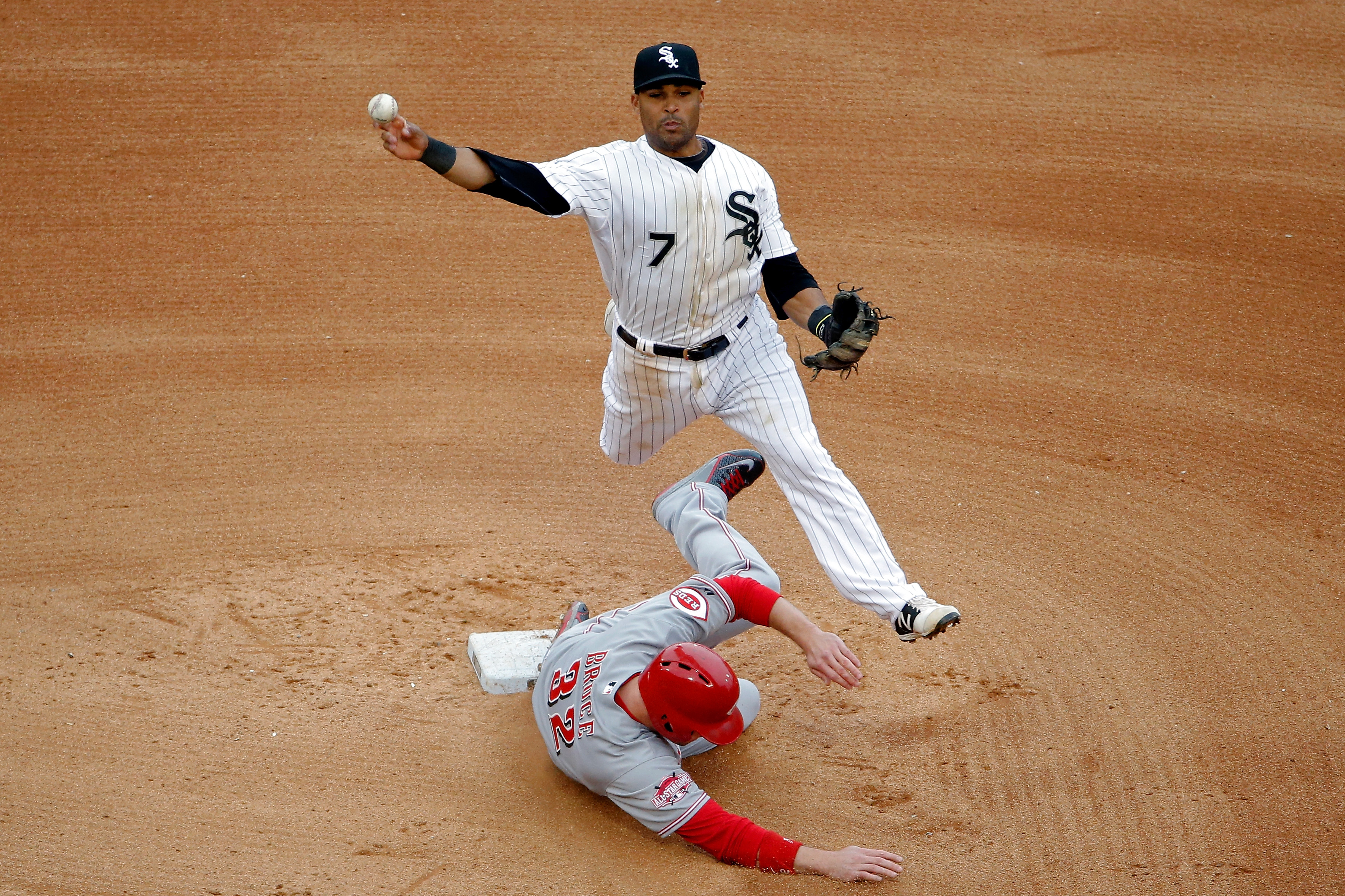 Micah Johnson #7 of the Chicago White Sox leaps in the air to throw to first base as Jay Bruce #32 of the Cincinnati Reds slides into second base during the sixth inning in the first game of a doubleheader on May 9, 2015 at U.S. Cellular Field in Chicago, Illinois. (Photo by Jon Durr/Getty Images) (Getty Images)