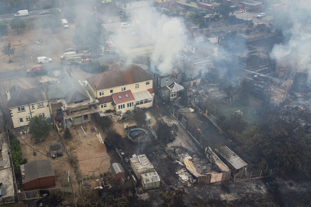 WENNINGTON, GREATER LONDON - JULY 19: In this aerial view, smoke from fires in a residential area being fought by fire services are seen on July 19, 2022 in Wennington, England. A series of grass fires broke out around the British capital amid an intense heatwave. (Getty Images—2022 Getty Images)