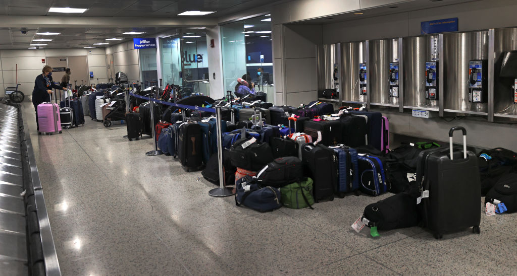 Passenger luggage left over at baggage claim from Jet Blue delays at Logan Airport Terminal C in Boston, Massachusetts, on April 5, 2022. (David L. Ryan—The Boston Globe/Getty Images)