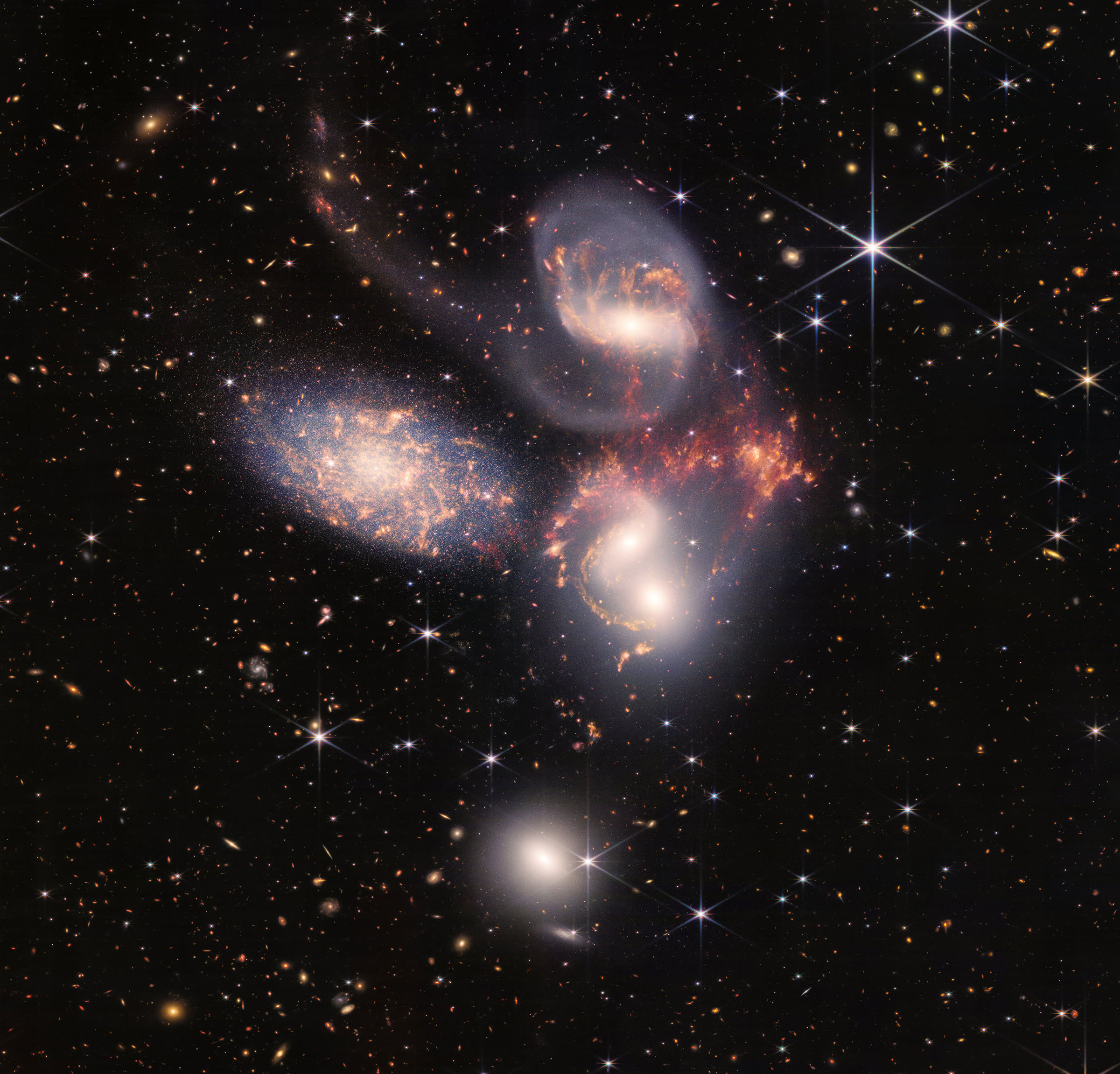 A group of five galaxies that appear close to each other in the sky: two in the middle, one toward the top, one to the upper left, and one toward the bottom. (NASA, ESA, CSA, STScI)