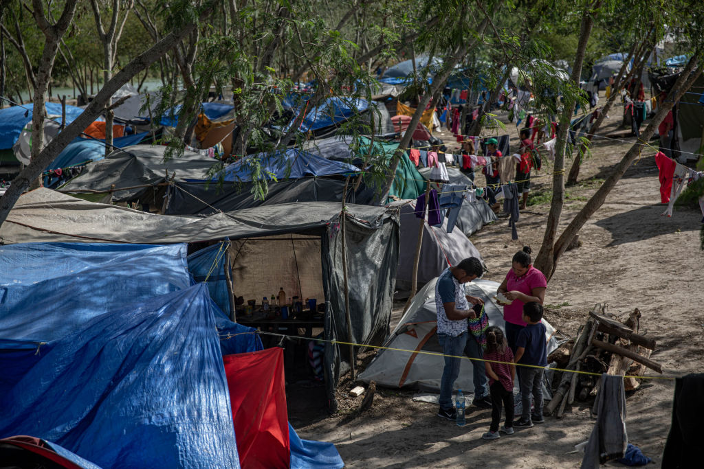 Clothing hangs to dry at a makeshift migrant camp for asylum seekers in Matamoros, Tamaulipas state, Mexico, on Sunday, March 1, 2020. The camp formed as the result of the Migrant Protection Protocols, also known as "Remain in Mexico" policy. (Alejandro Cegarra—Bloomberg/Getty Images)