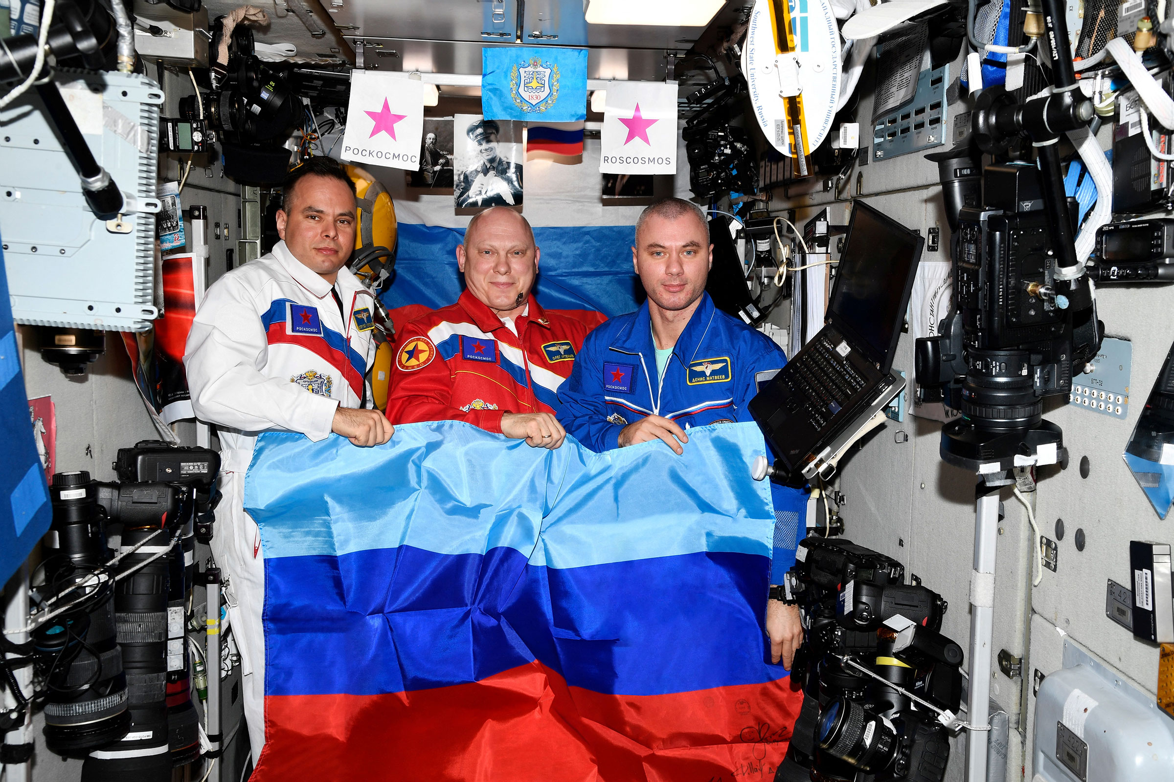 Russian cosmonauts pose with a flag of the self-proclaimed Luhansk People's Republic aboard the International Space Station (Roscosmos/Handout/Reuters)