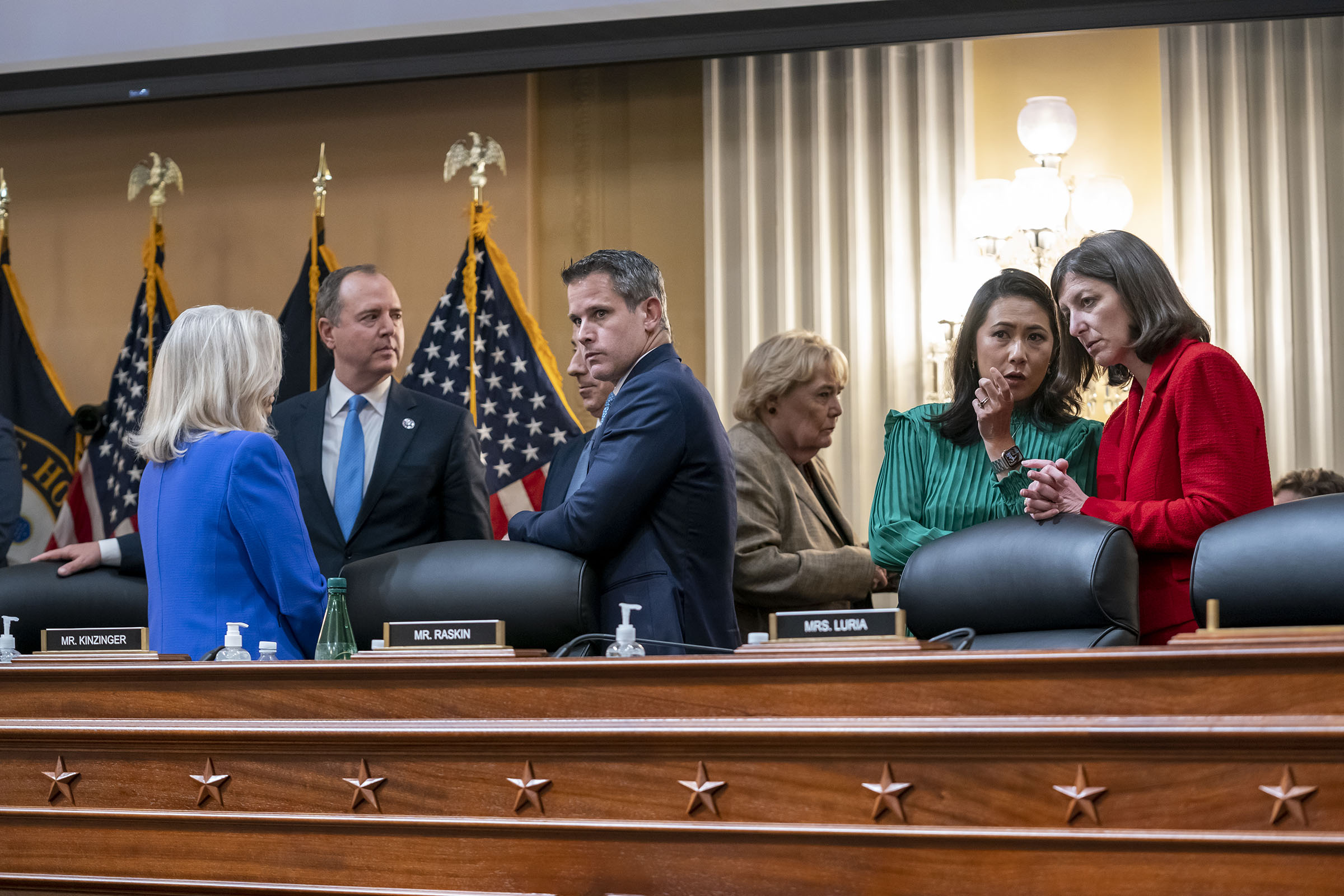 From left Vice Chair Liz Cheney, R-Wyo., Rep. Adam Schiff, D-Calif., Rep. Jamie Raskin, D-Md., partially obscured, Rep. Adam Kinzinger, R-Ill., Rep. Zoe Lofgren, D-Calif., Rep. Stephanie Murphy, D-Fla., and Rep. Elaine Luria, D-Va., during a break at a public hearing to reveal the findings of a year-long investigation on the Jan. 6 attack on the U.S. Capitol, June 9, 2022. (J. Scott Applewhite—AP)