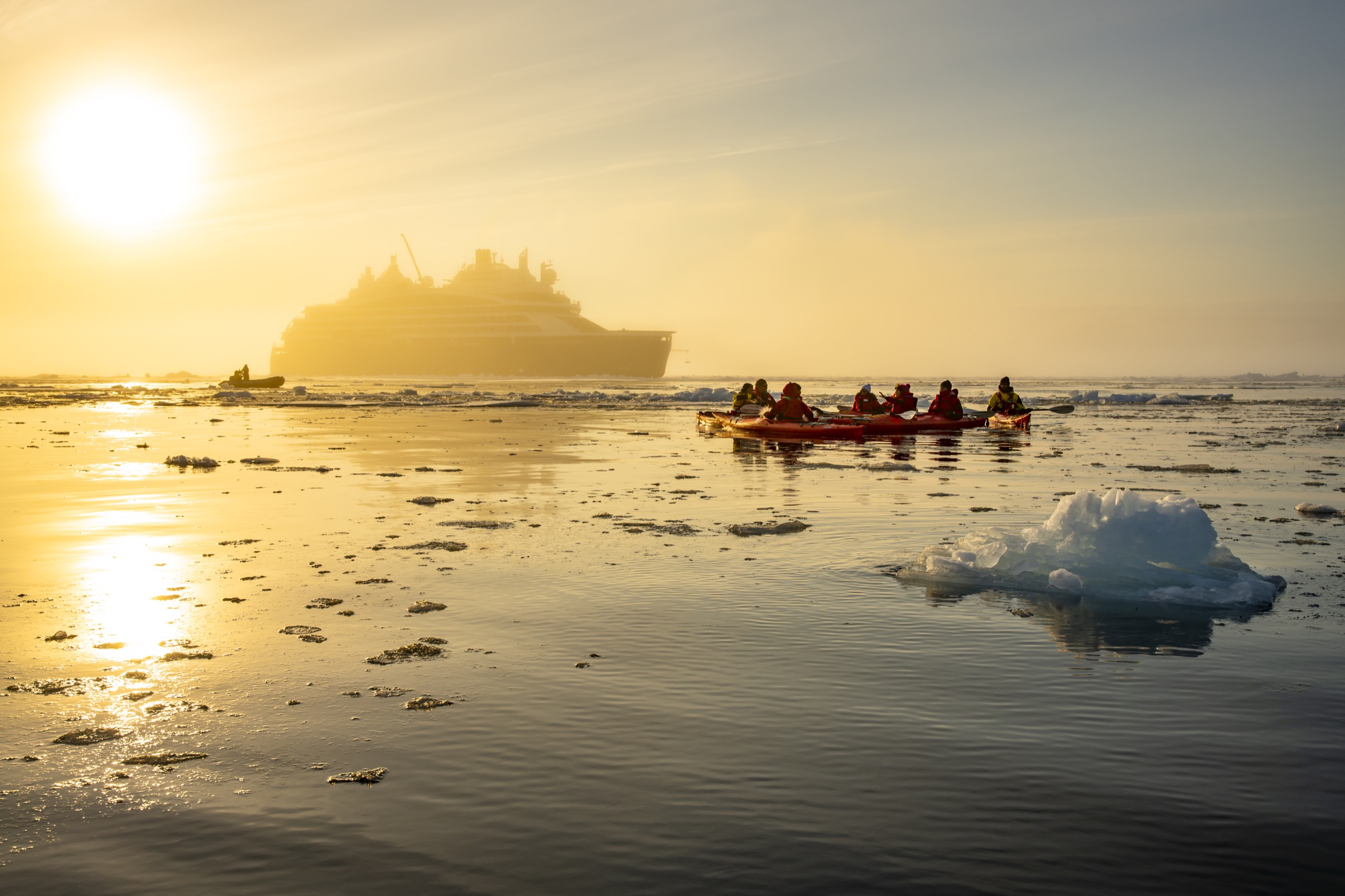 Kayakers around Ponant's Le Commandant Charcot, a passenger ship that takes travelers to the Geographic North Pole. (Olivier Blaud—PONANT)