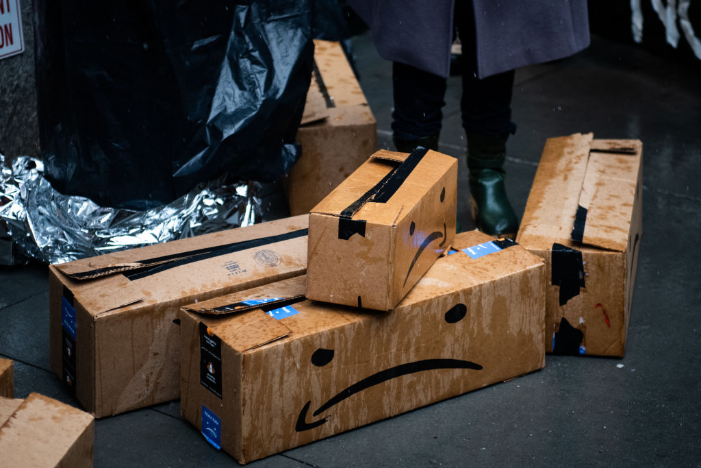 Satirical shipping boxes sit outside the penthouse of Jeff Bezos, founder of Amazon, during a protest against Amazon in New York, U.S., on Monday, Dec. 2, 2019. (Mark Kauzlarich—Bloomberg/Getty Images)