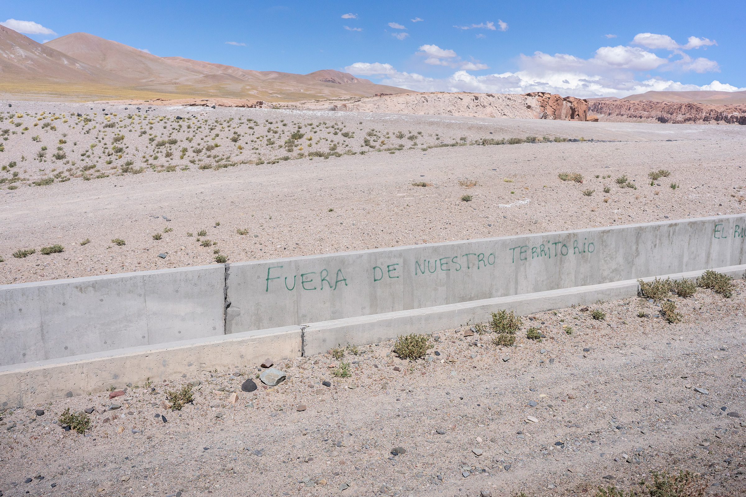 Activists have scrawled 'Get off our land' on an aqueduct at Livent's Hombre Muerto lithium mine. (Sebastián López Brach for TIME)