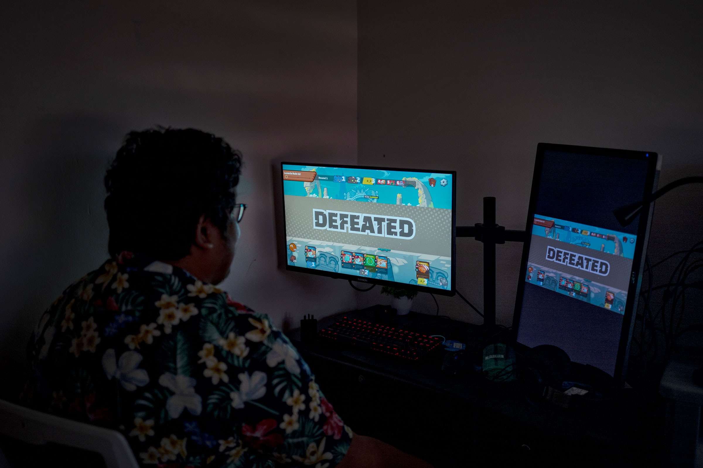 Albert Oasnon, an Axie "manager", plays the game at his home in Imus, Cavite, in the outskirts of Manila, Philippines, on July 19, 2022. Oasnon, who works in content marketing and also runs a small media company, says that during the game's peak last year, he was managing around 20 scholars. (Ezra Acayan for TIME)