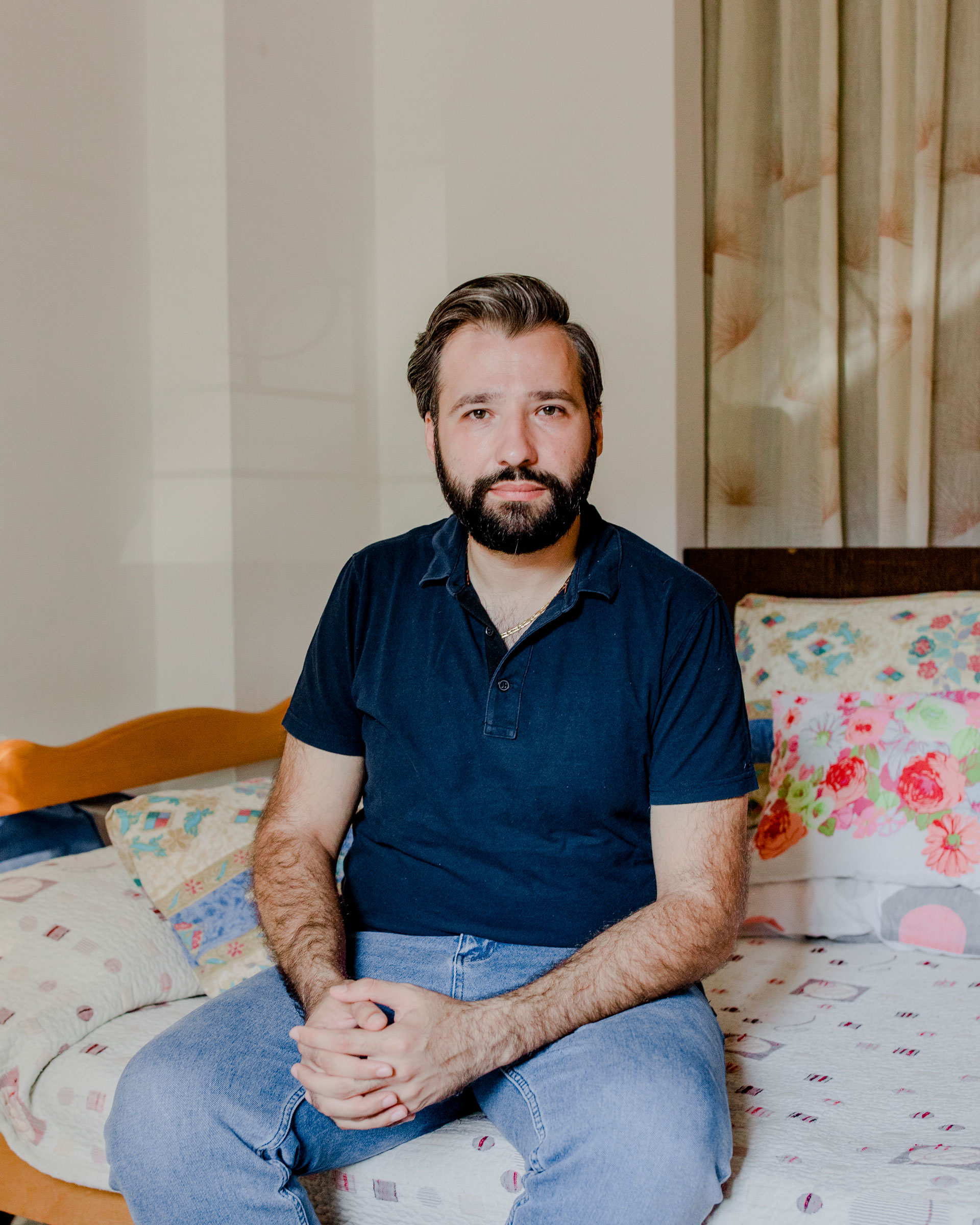 Elie Hasrouty at home in Sin El Fil on July 20. This used to be his father's bed, but Elie started sleeping in it after his father passed away in the August 2020 explosion