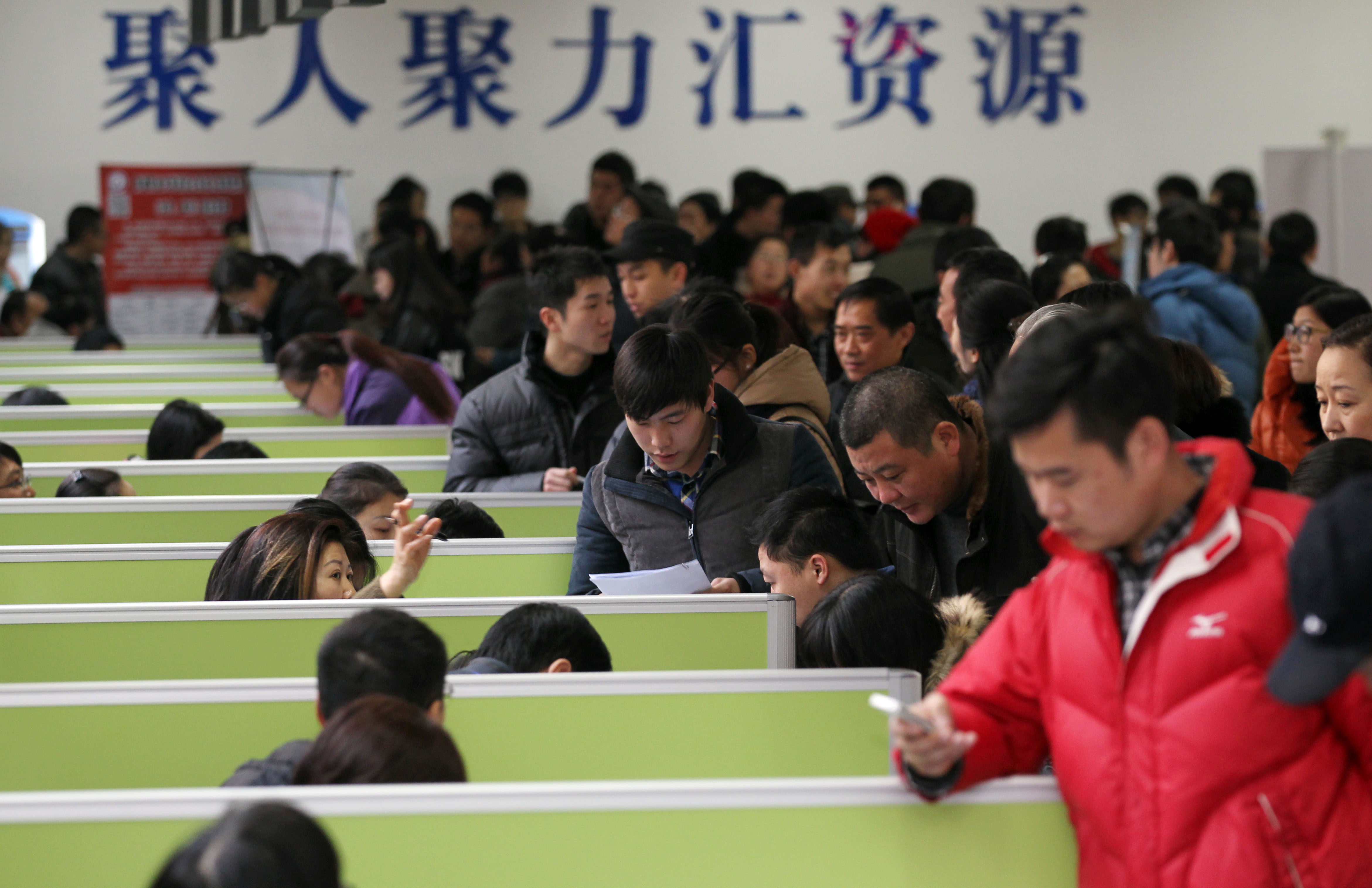 Chinese job seekers crowd stalls at a job fair in Nantong city, east China's Jiangsu province. (Xu Congjun/Imaginechina)