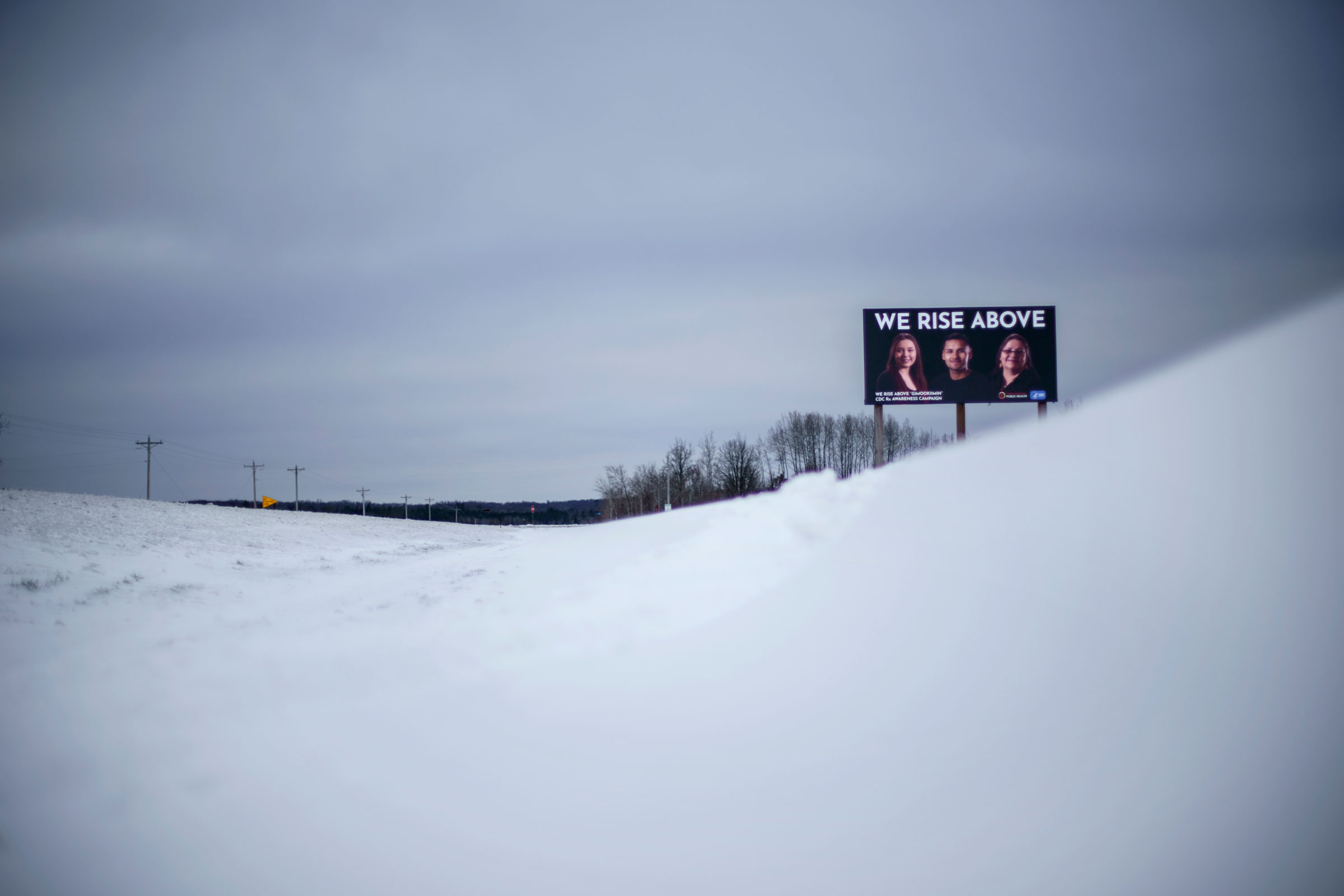A billboard, part of an awareness campaign to combat prescription opioid abuse in the Native community, stands along a road