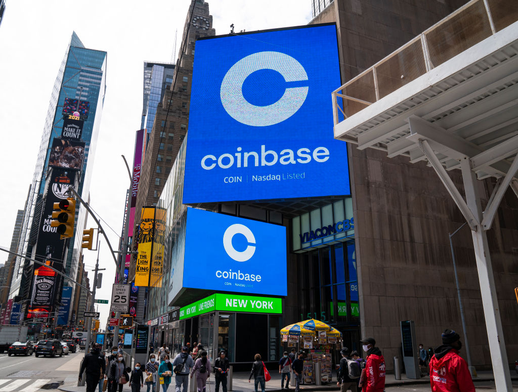 Monitors display Coinbase signage during the company's initial public offering (IPO) at the Nasdaq market site April 14, 2021 in New York City. (Robert Nickelsberg—Getty Images)