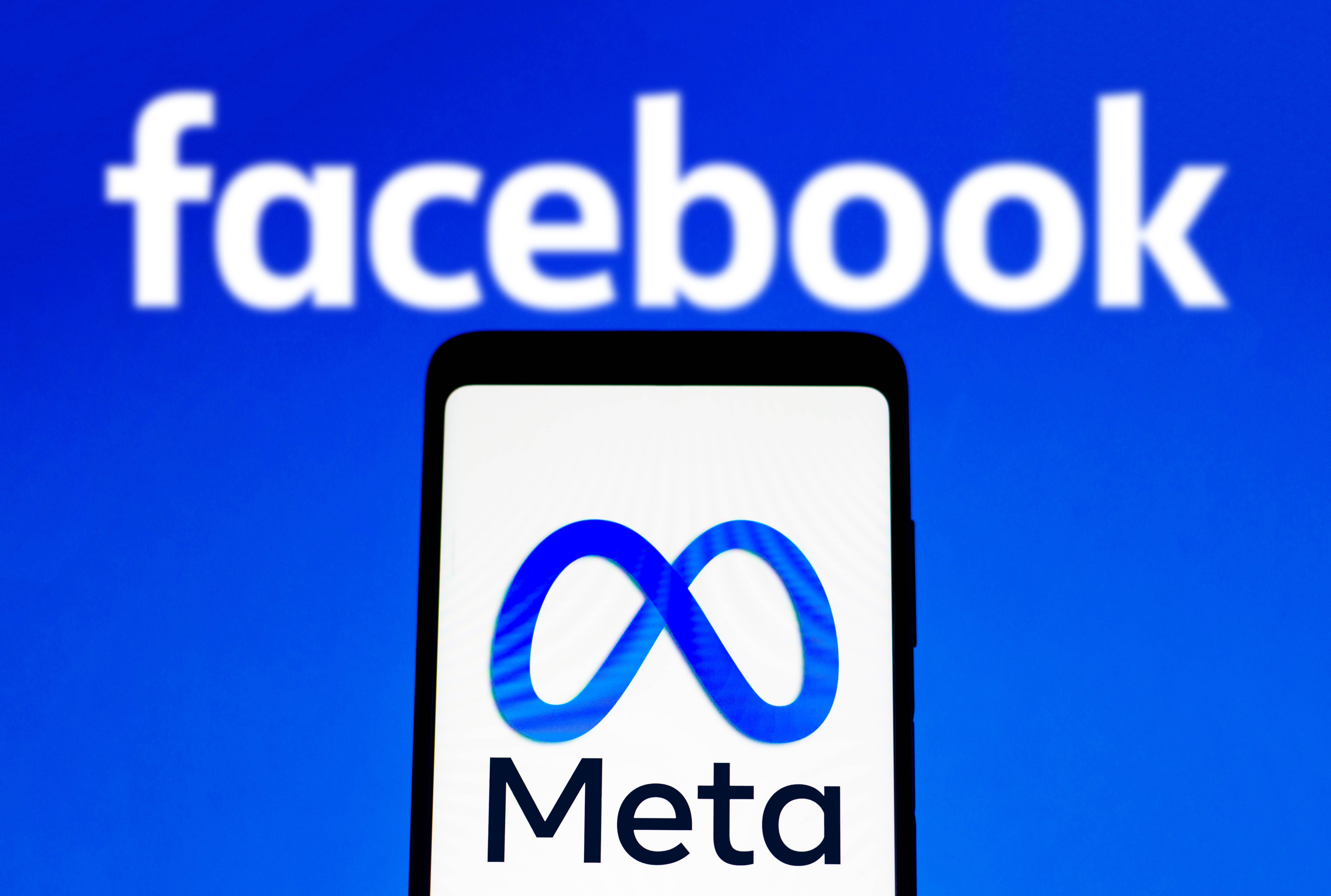 In this photo illustration, a Meta Platforms logo is displayed on a smartphone screen with a Facebook logo in the background. (Rafael Henrique—SOPA Images/LightRocket/Getty Images)