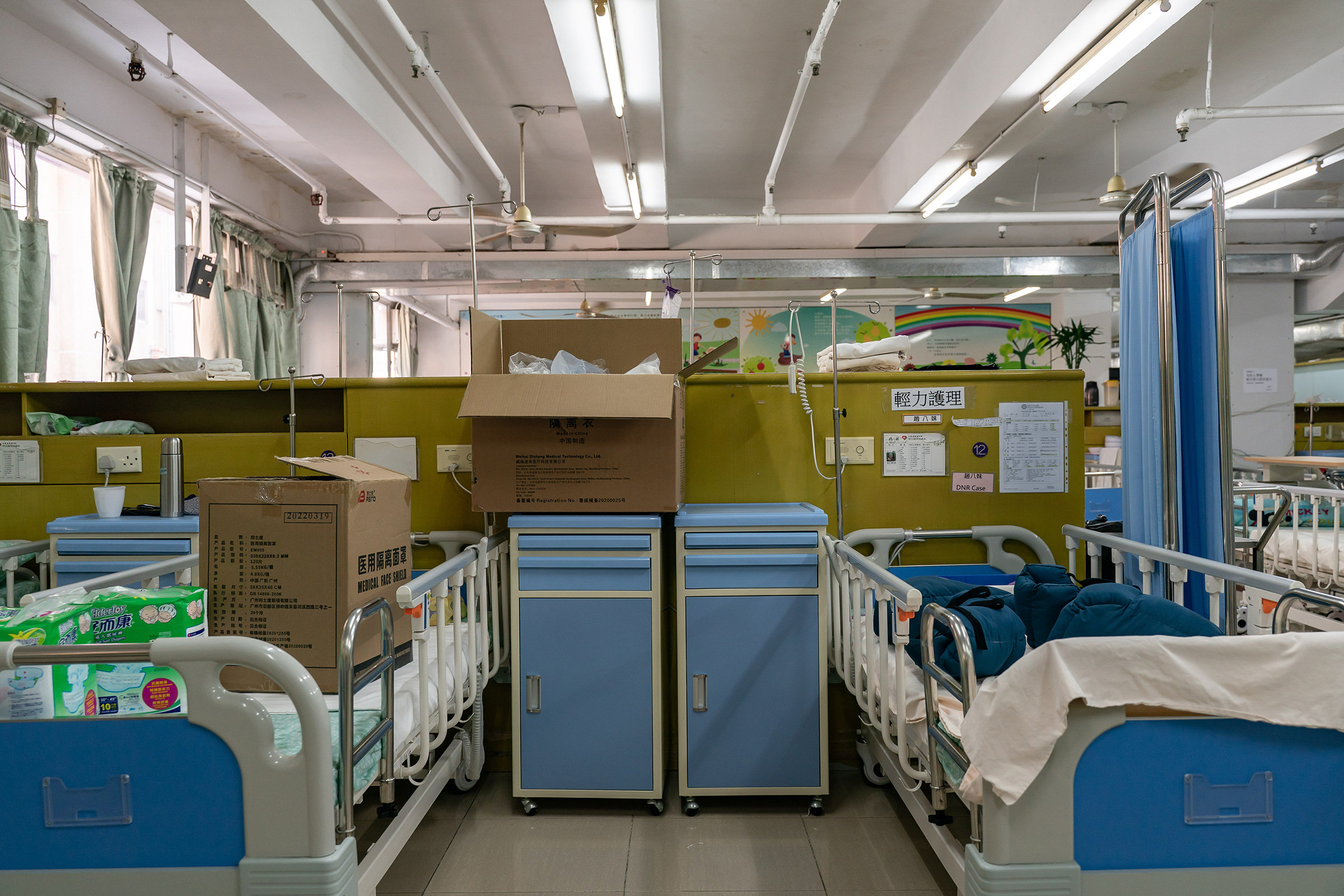 Boxes of supplies on empty beds in zone 6 of the Kei Tak (Tai Hang) Home For The Aged in Yuen Long district on May 6, 2022 in Hong Kong, China. Zone 6 is where the elderly needing the most care stay in the nursing home.