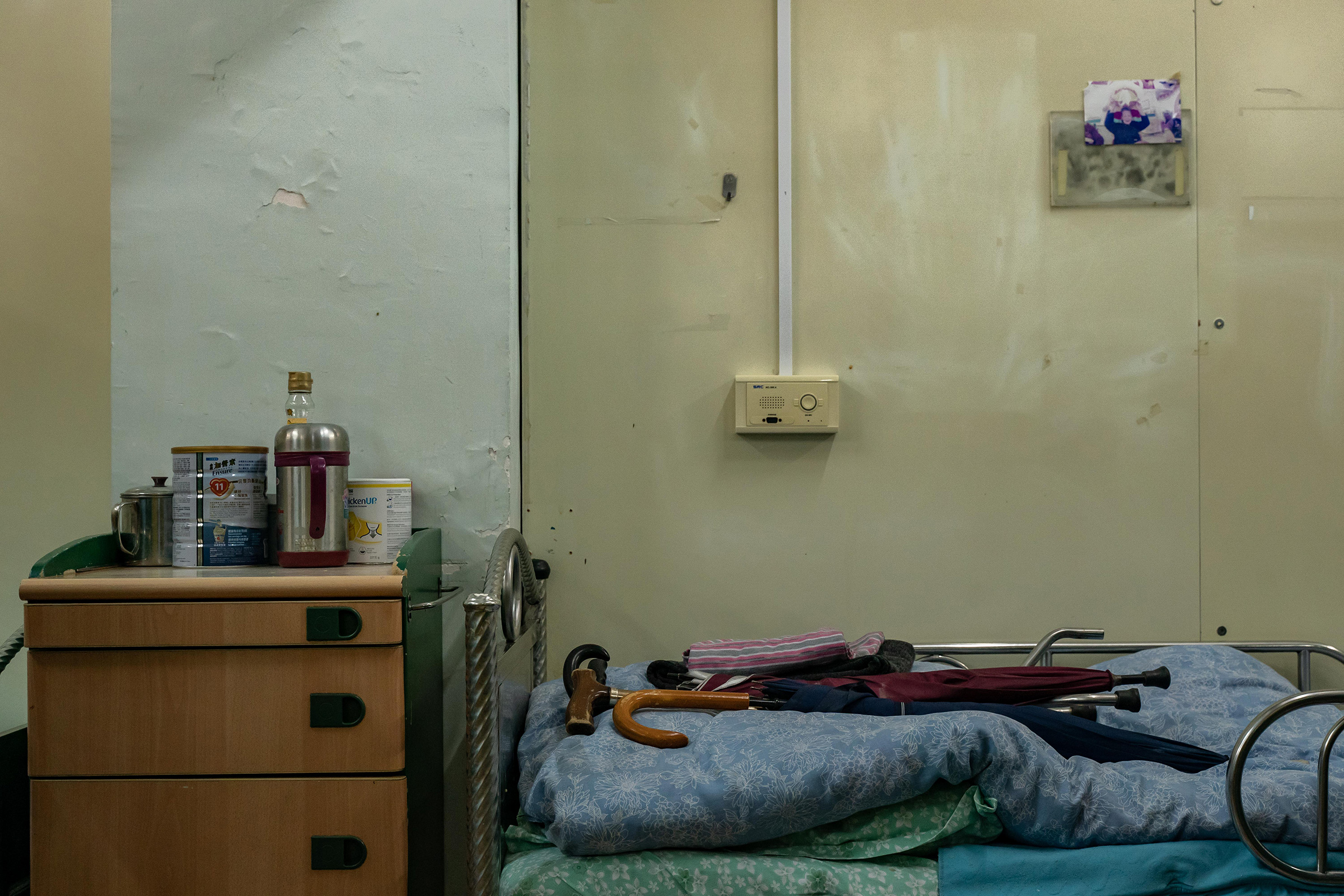 Personal effects left by a deceased resident, seen on a bed at Hong Kong's Kei Tak (Tai Hang) Home for the Aged. (Anthony Kwan for TIME)
