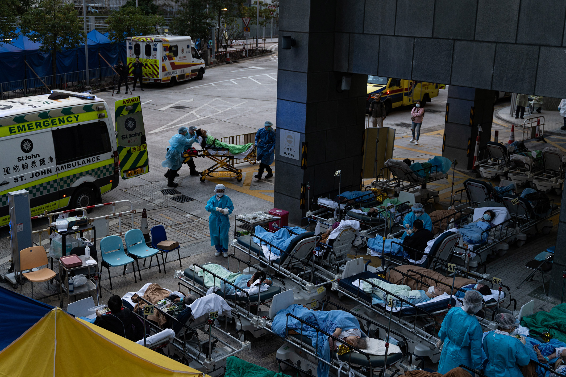Patients lie in a temporary holding area outside Caritas Medical Center in Hong Kong on Feb. 16, 2022. (Leung Man Hei—NurPhoto/Reuters)