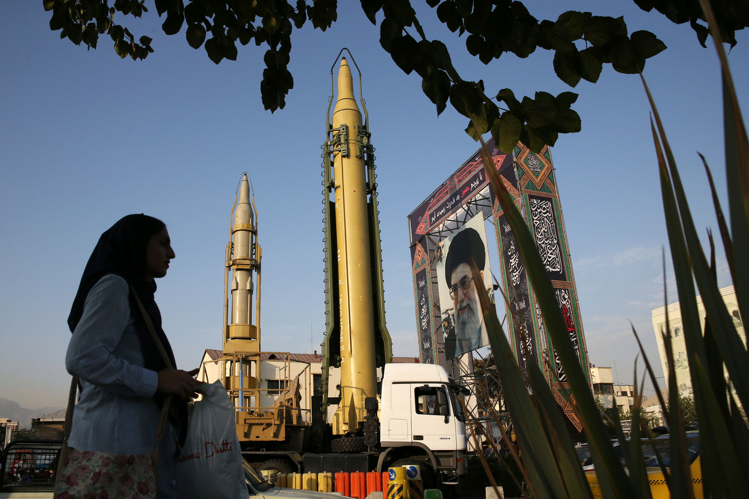 A Ghadr-H missle, center, a solid-fuel surface-to-surface Sejjil missile and a portrait of the Supreme Leader Ayatollah Ali Khamenei are on display for the annual Defense Week, marking the 37th anniversary of the 1980s Iran-Iraq war, at Baharestan Sq. in Tehran, Iran, Sept. 24, 2017. (Vahid Salemi—AP)