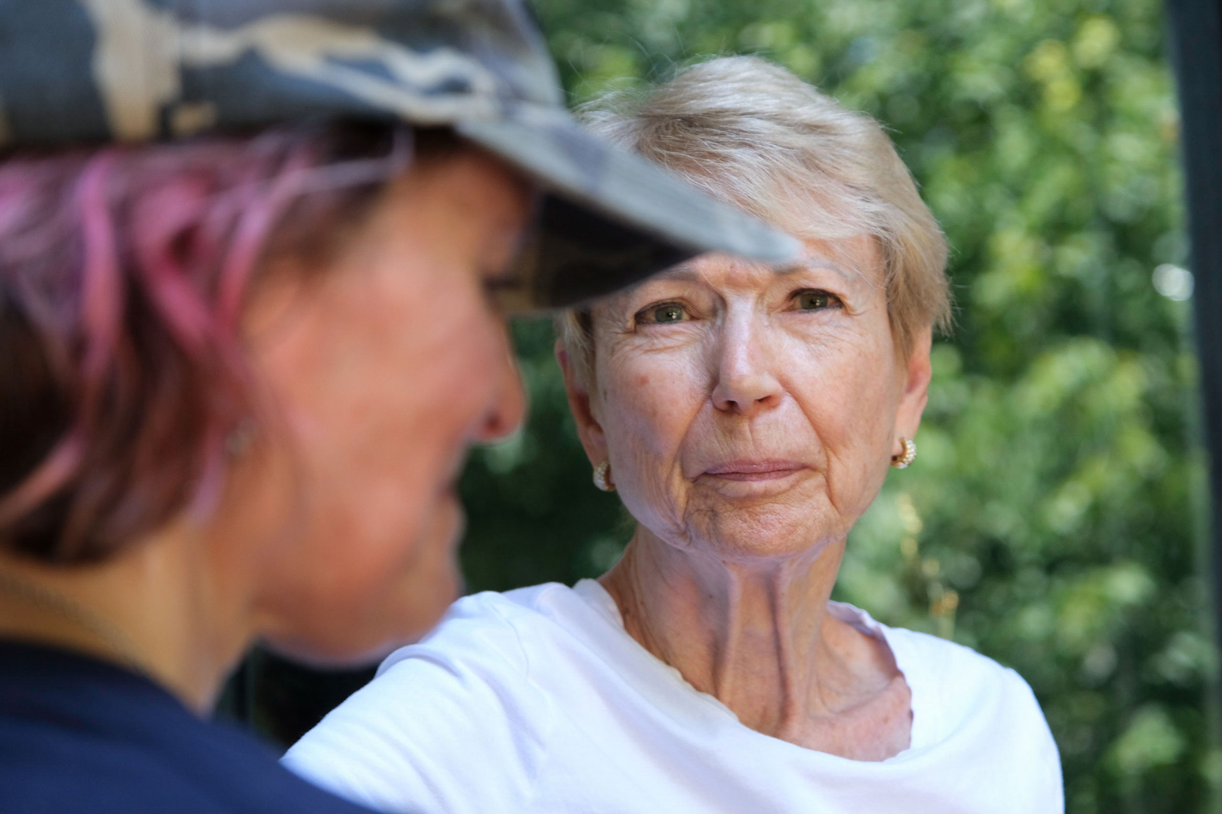 Anne Melia speaks with Dottie Jensen, 87, while canvassing for Kansans for Constitutional Freedom in Leawood, Kansas on July 23, 2022. Jensen said she plans to vote "no." Arin Yoon for TIME.