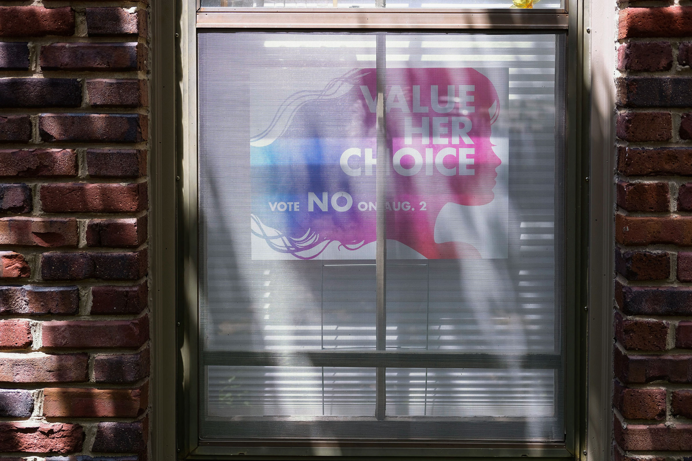 A 'Value Her Choice' sign is displayed in window of a home in Leawood, Kansas on July 23, 2022. Arin Yoon for TIME.