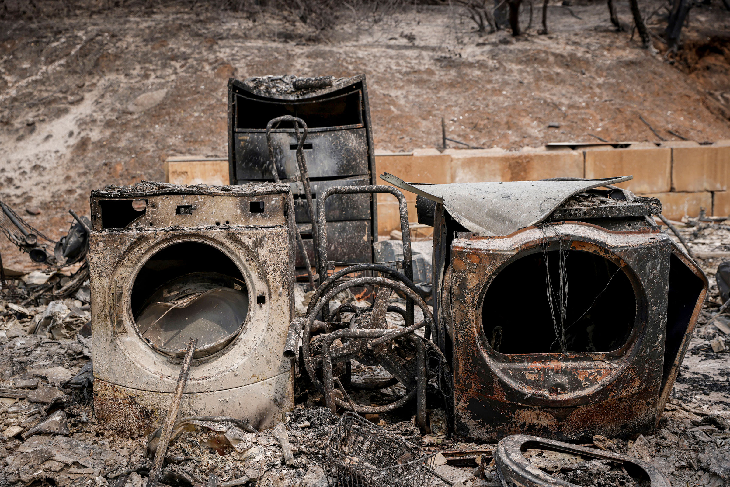 Debris from a burned home is seen after flames from the Oak Fire swept through Triangle Road in Mariposa County on July 26. (Brontë Wittpenn—San Francisco Chronicle/AP)