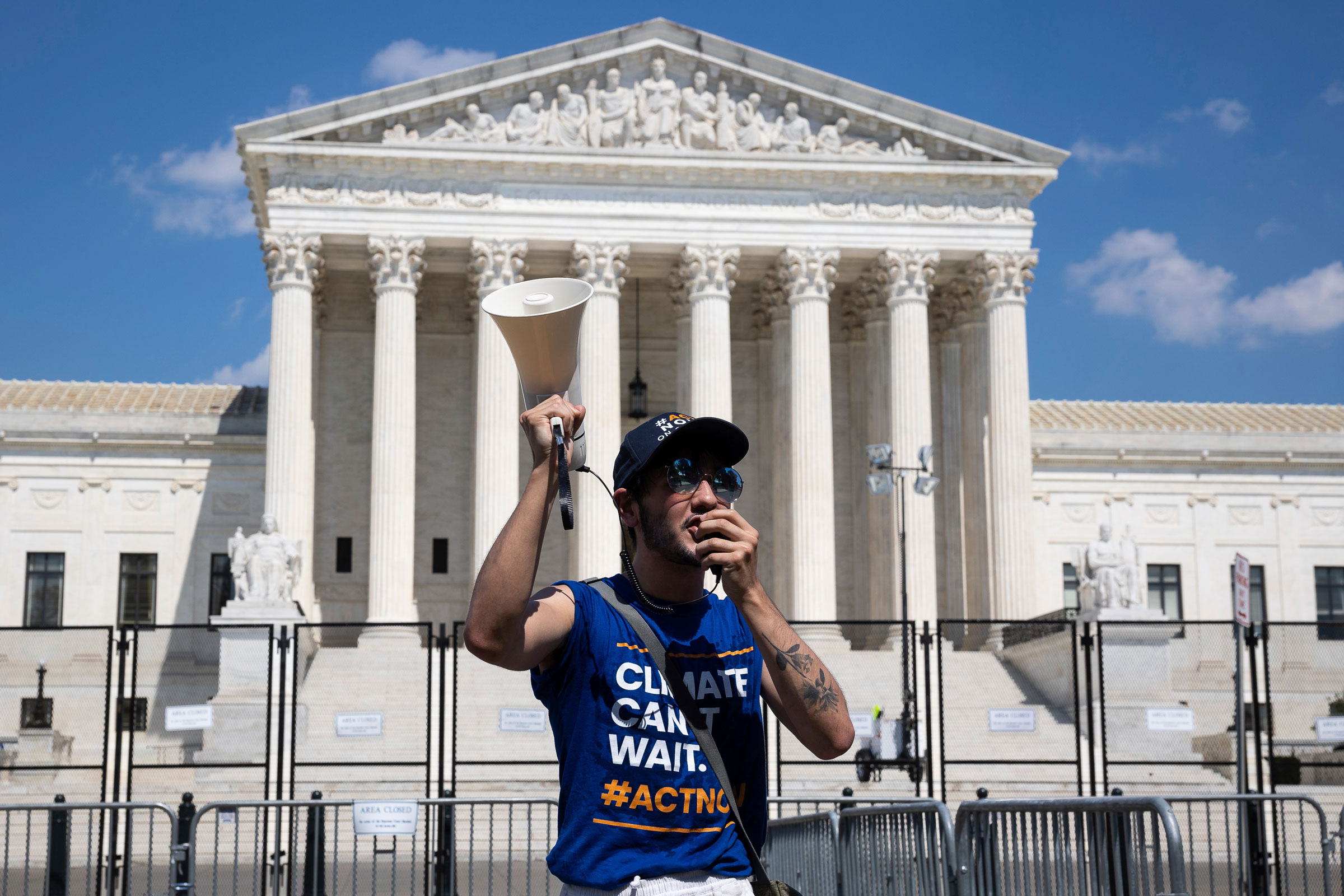an activist with the Climate Action Campaign protests outside the U.S. Supreme Court
