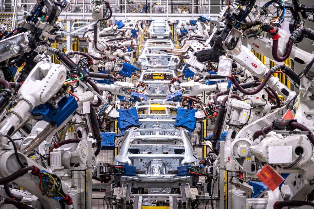 Assembly robots put together car bodies in the body shop at VinFast manufacturing plant